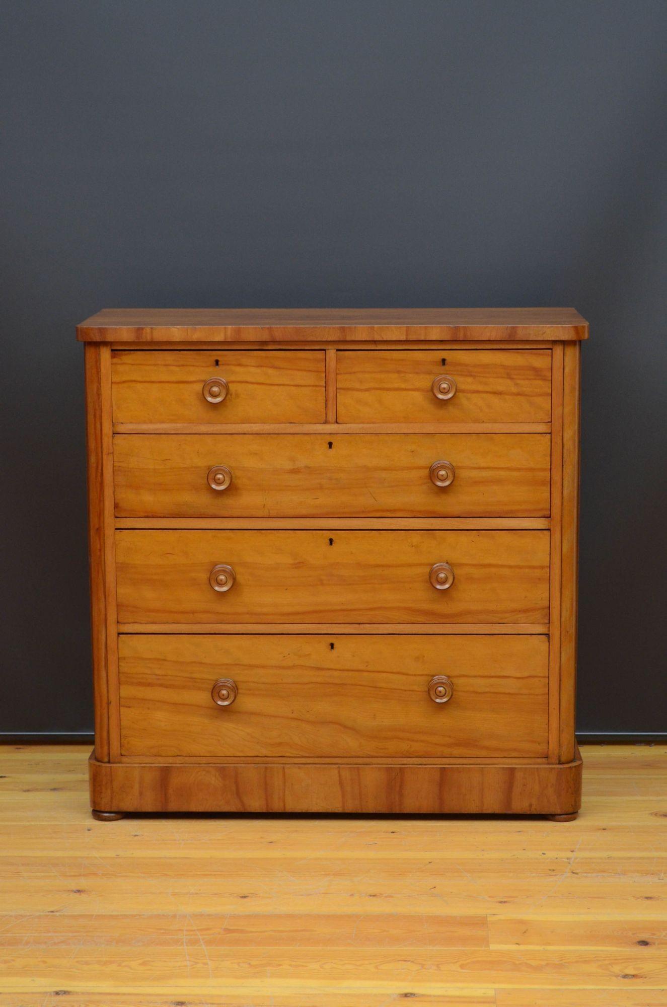 Sn5492 Attractive Victorian chest of drawers in satinwood with rounded corners, having oversailing top above two short and three long and graduated drawers, all fitted with original turned knobs, all standing on plinth base and bun feet. This