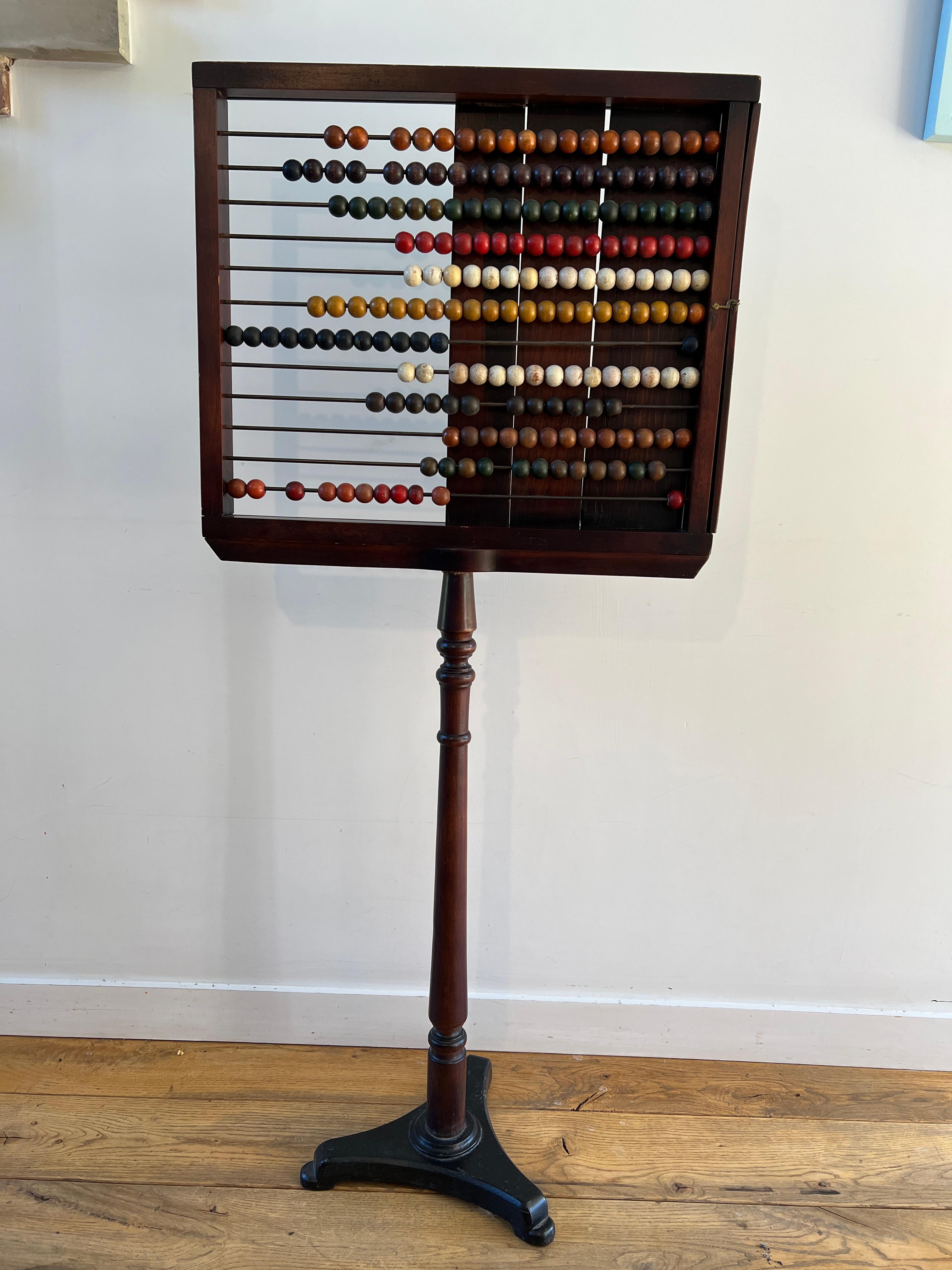 A wonderful mid 19th century School Abacus, polished mahogany with a cast iron base, all complete and original, these are normally found in very poor condition after spending many years at the hands of young children in the school, this example