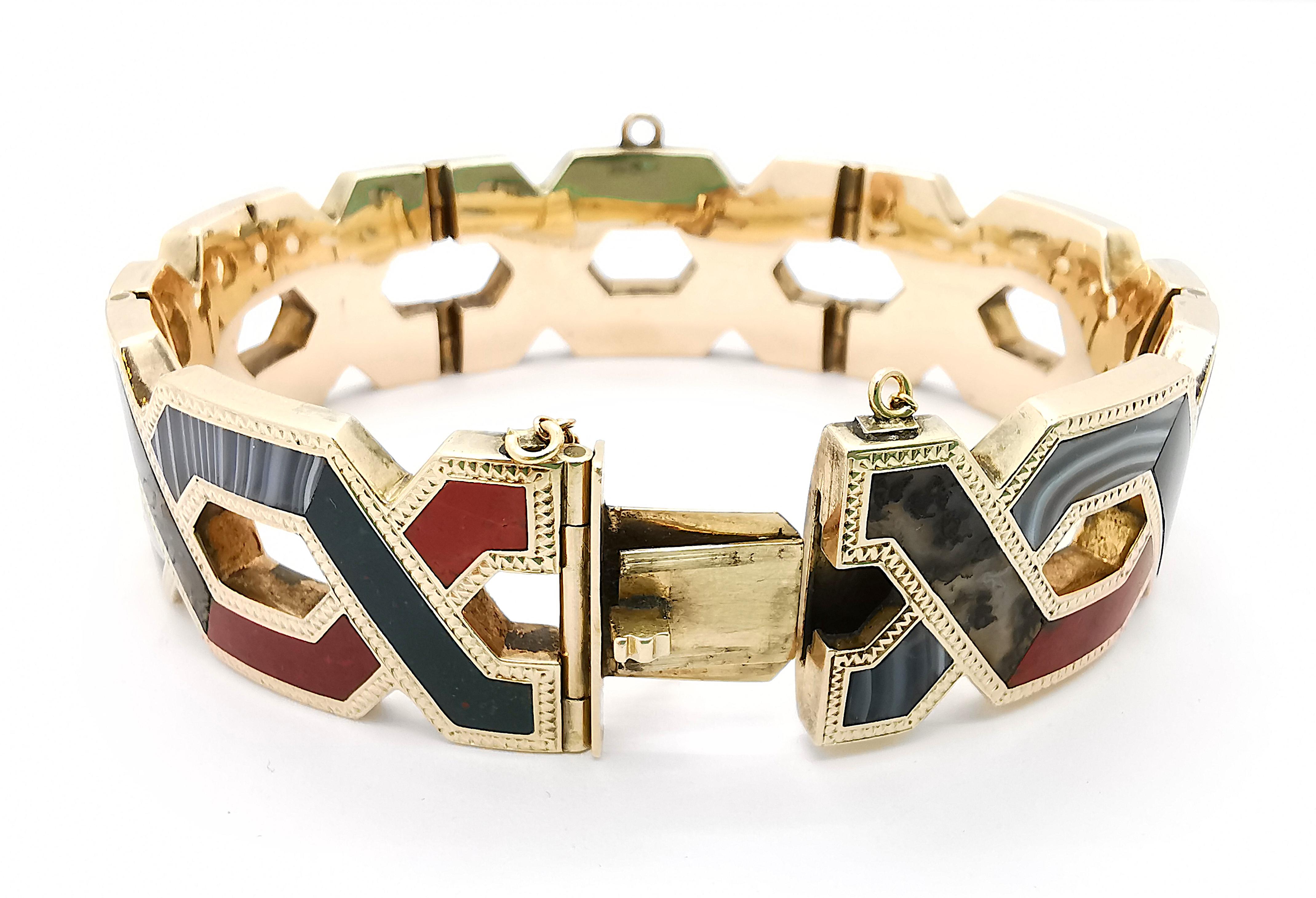 A Victorian Scottish agate bracelet, comprised of five panels with hinge links between, forming a repeating crossover pattern, inlaid with a combination of agates and jaspers, including banded agate, bloodstone and red jasper, mounted in gold with a
