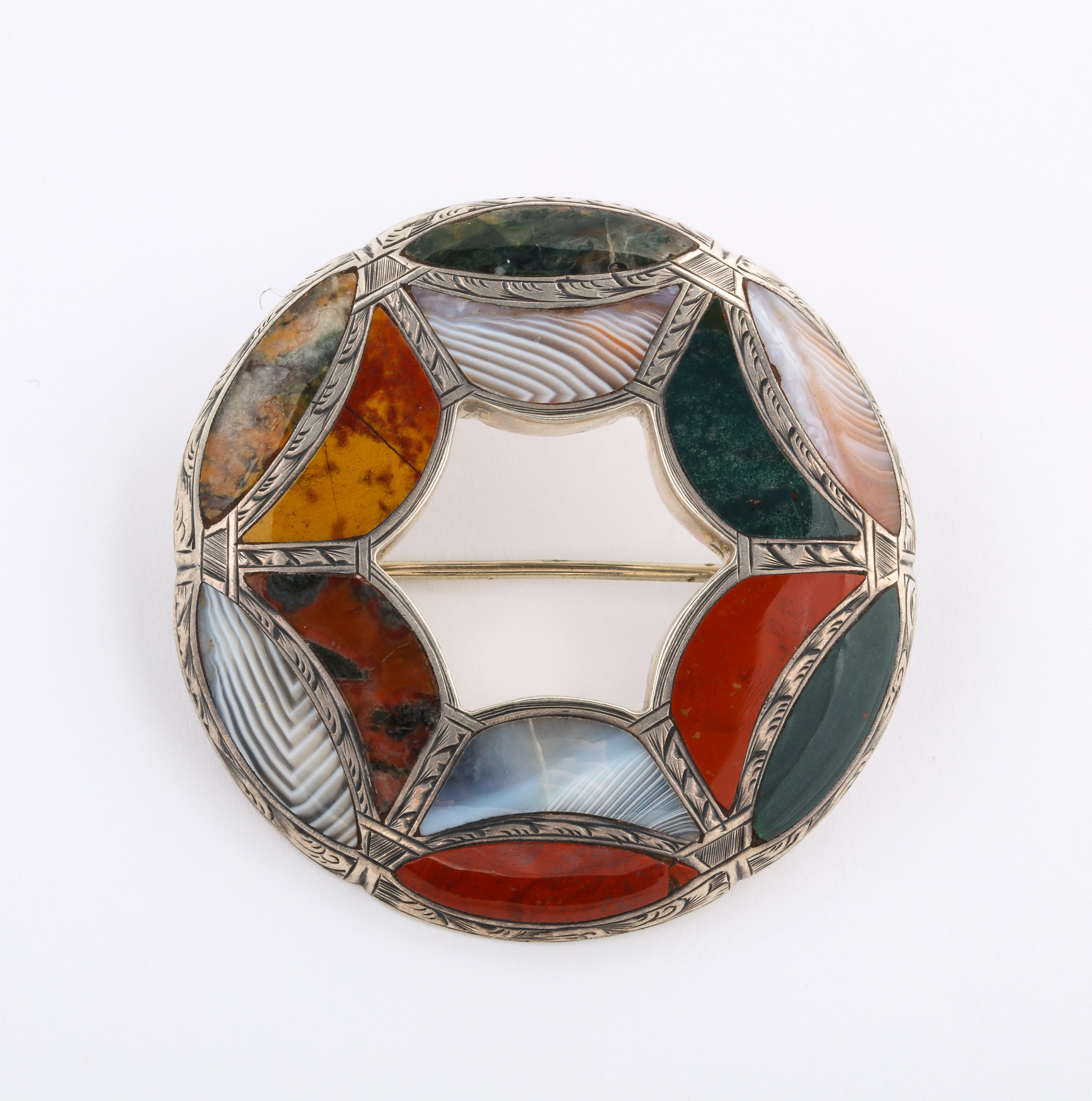 A Victorian Scottish agate brooch shows you the exceptional stone cutting and placing of various agates in sterling silver. The agates are a splendid show of rare agates including moss agate and Montrose striped agate cut in half moon pieces.
