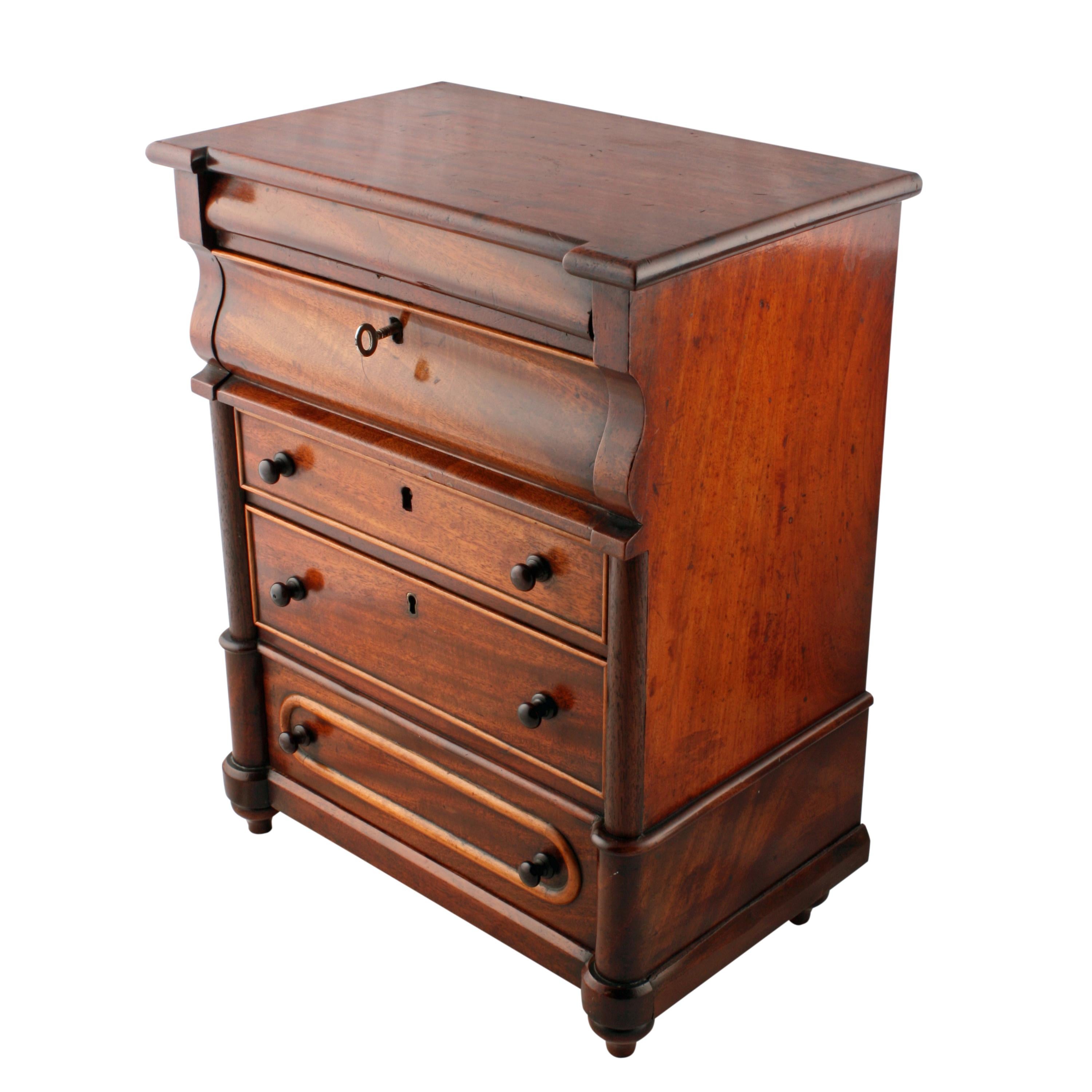 A middle of the 19th century Victorian miniature Scottish mahogany chest of drawers.

The chest could have been made as a salesman's sample and is an exact miniature of the full size chest.

The chest has five working drawers, the middle three