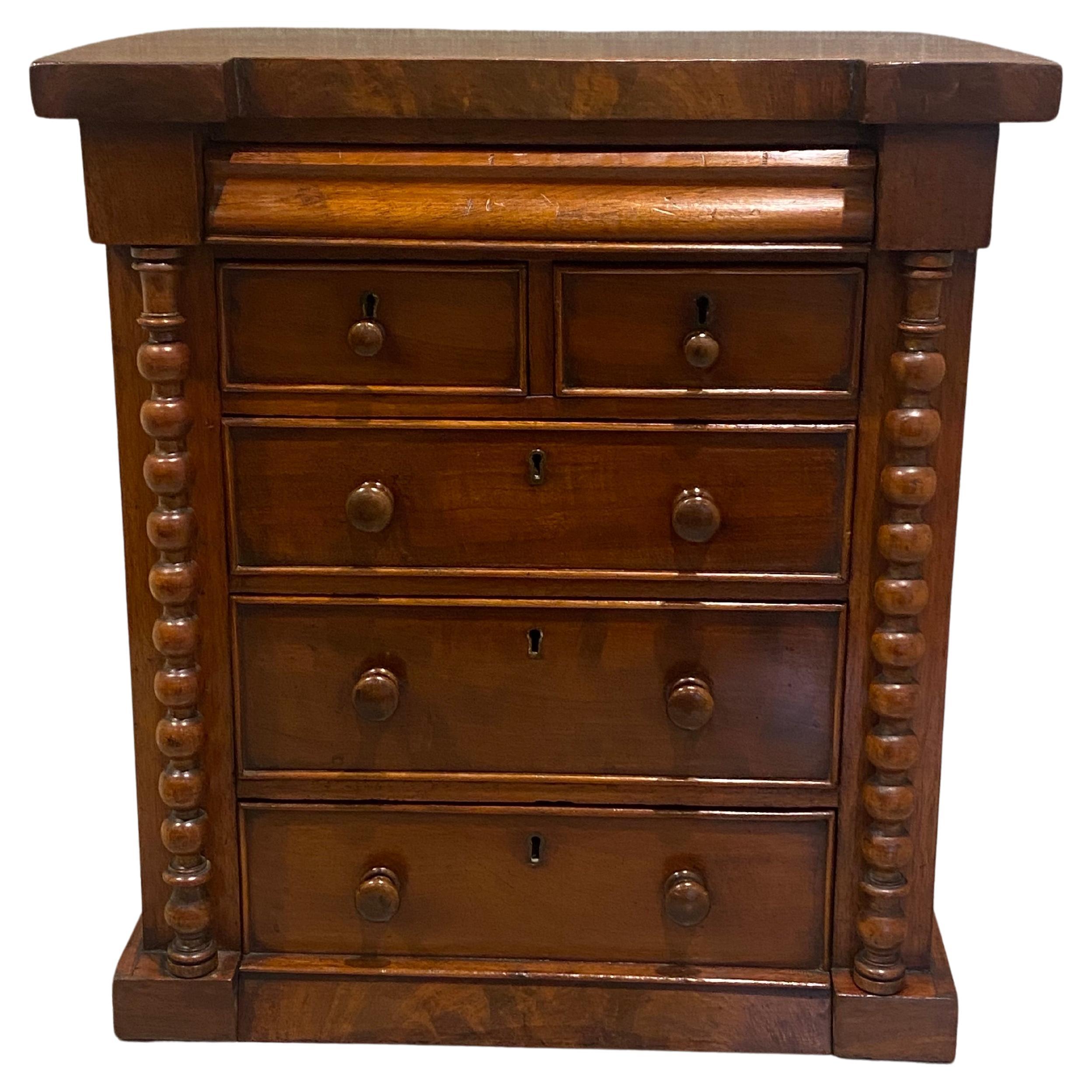 A Very rare Scottish antique chest of drawers having two barley-twist columns flanking each side, 3 large drawers 2 small upper drawers and there is another hidden secret drawer at the very top. This Superb Collectors Chest is in very good condition