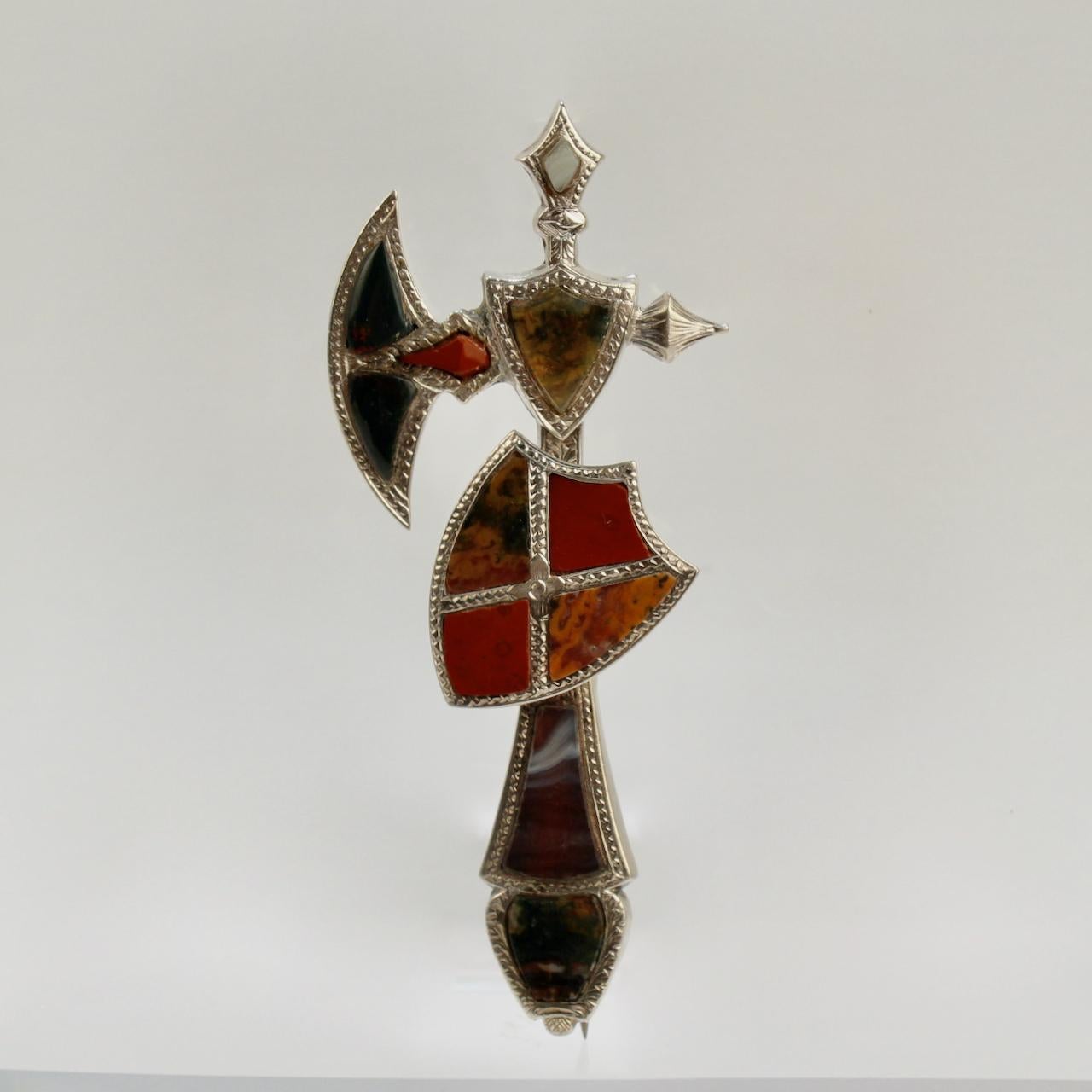 A very fine Victorian Scottish agate brooch in the shape of a battle axe and shield.

With a variety of shaped agate specimens set in sterling silver.  

An amazing piece of Scottish Victoriana!

Date:
19th Century

Overall Condition:
It is in