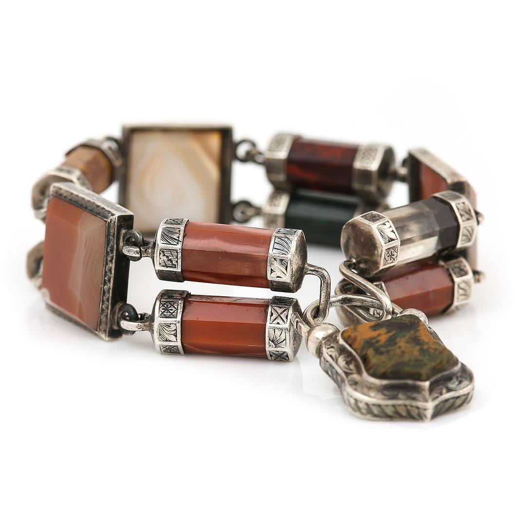 A beautiful Victorian Scottish agate bracelet set in delicately engraved silver details. Each banded agate piece is totally unique and boasts various earthy hues from deep greens to browns, reds and creams with the banding all naturally formed,