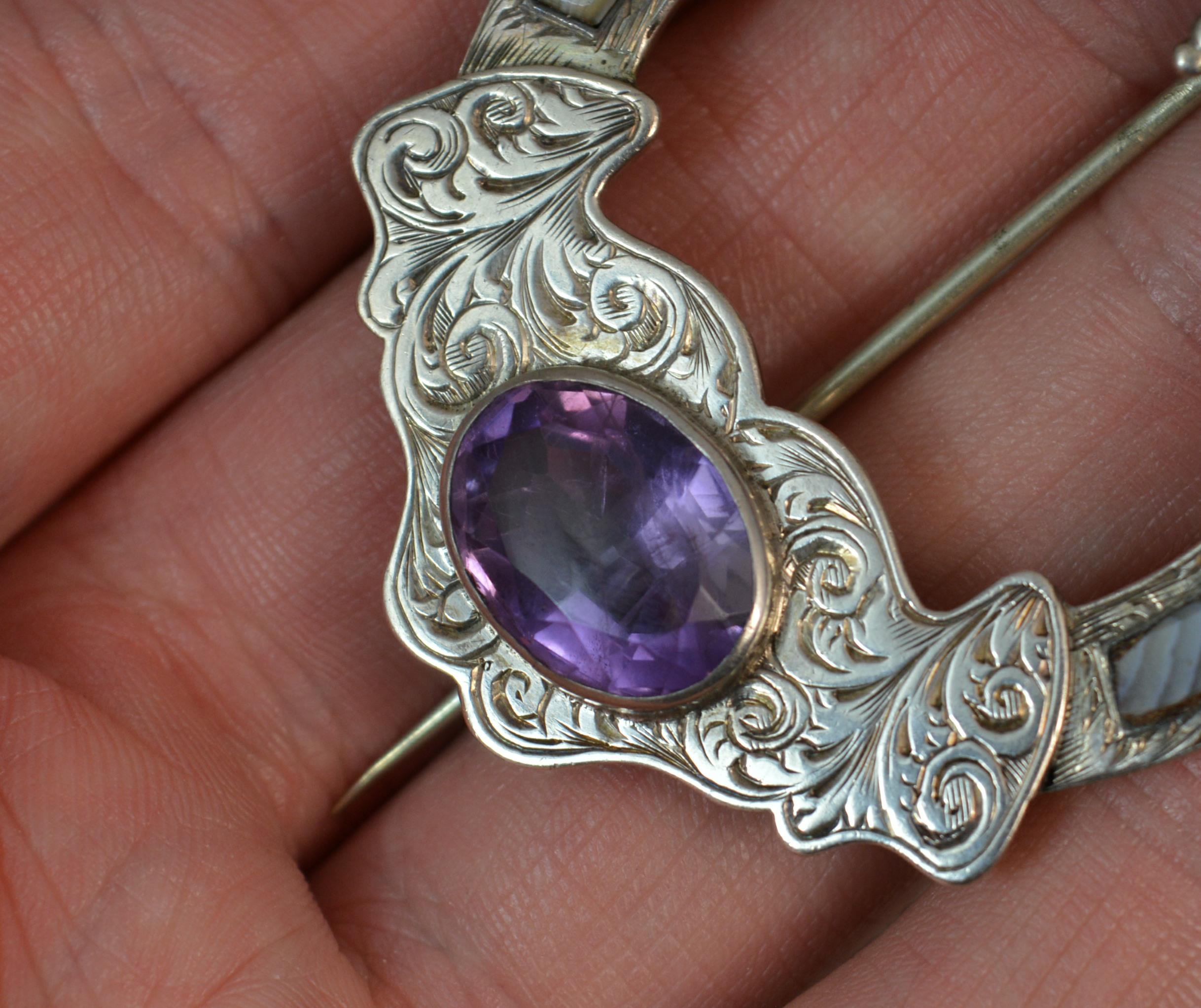 A beautiful antique silver, agate and amethyst brooch.
Scottish origin.
Fine engraved floral pattern to silver.
Stylish shape.

Hallmarks ; n/a
Weight ; 15.1 grams
Size ; 44mm x 62mm approx
Condition ; Very good. Working pin and hinge. Securely set