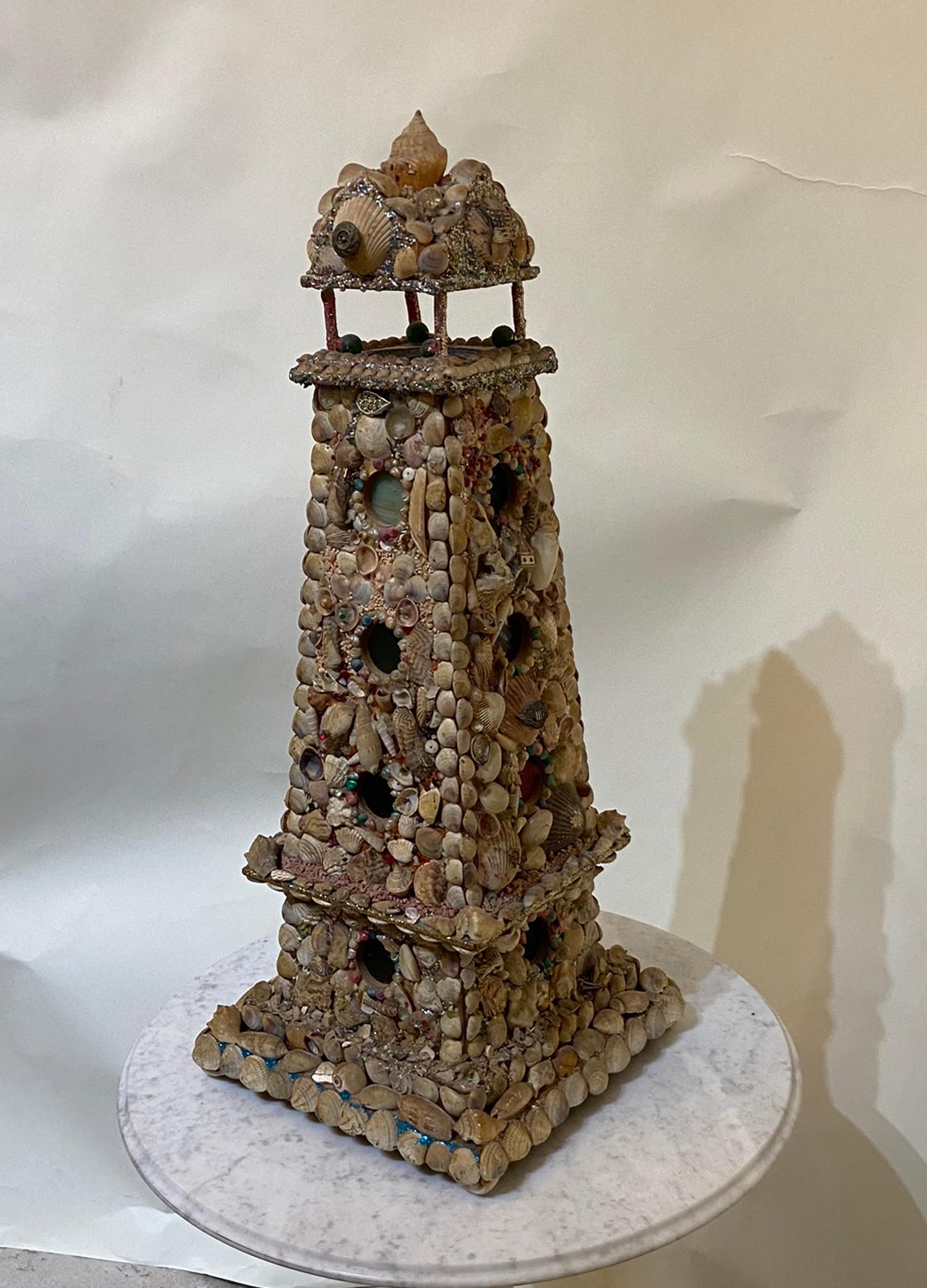 Victorian sea shell art. Tall light house with a night light in the top. From the early 20th century overall in very good condition. A few missing shells