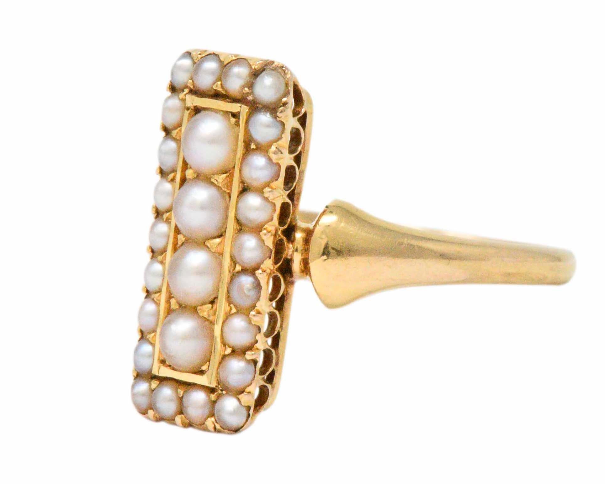 Centering four seed pearls
Within a smaller seed pearl frame
The ring is engraved 