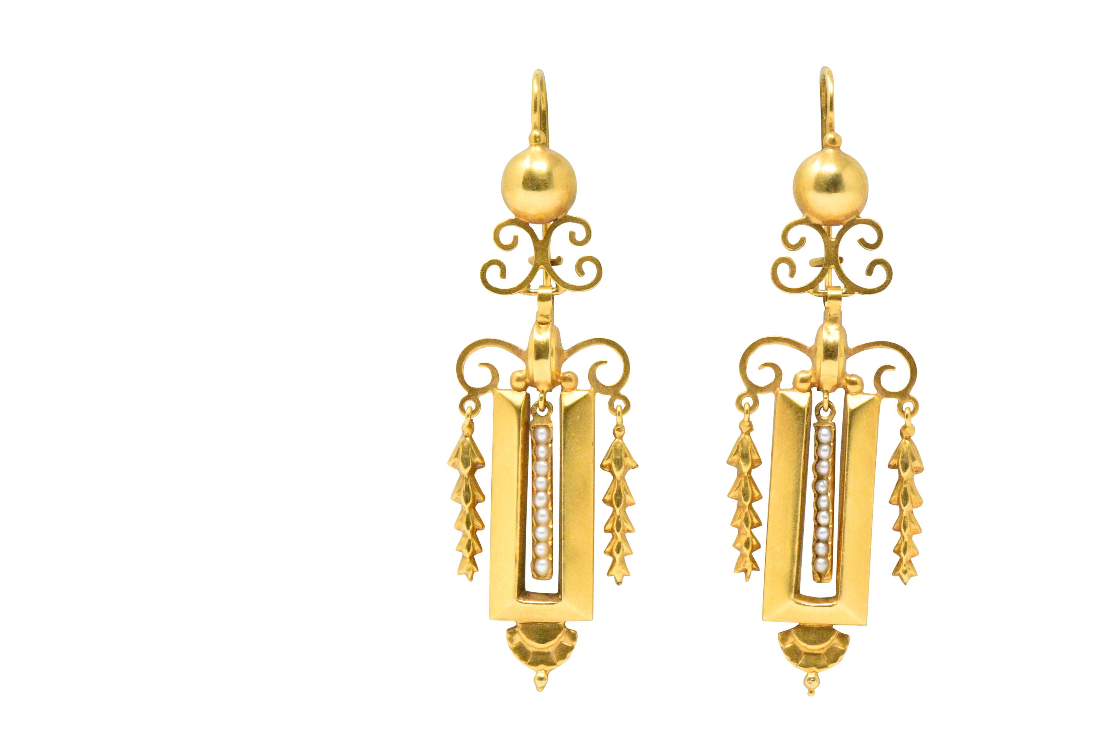 Open articulated drop earring centering delicate seed pearls

With scrolling, detailed and polished gold details

In the warm soft look of gold that you get from Victorian gold pieces

From the late romantic period of the Victorian era, circa