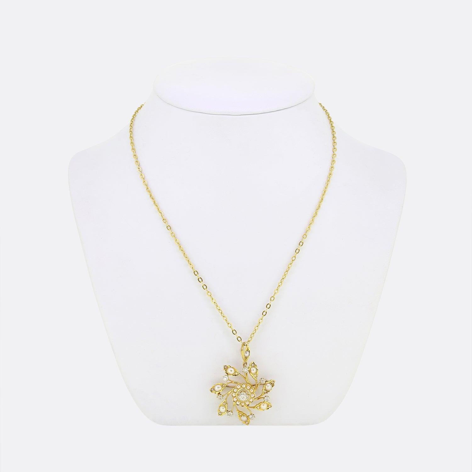 This is a Victorian pearl and diamond necklace. The piece showcases a heavily detailed, hand crafted sunflower pendant crafted in 15ct yellow gold and features an array of seed pearls and old cut diamonds. The pendant is suspended from a matching