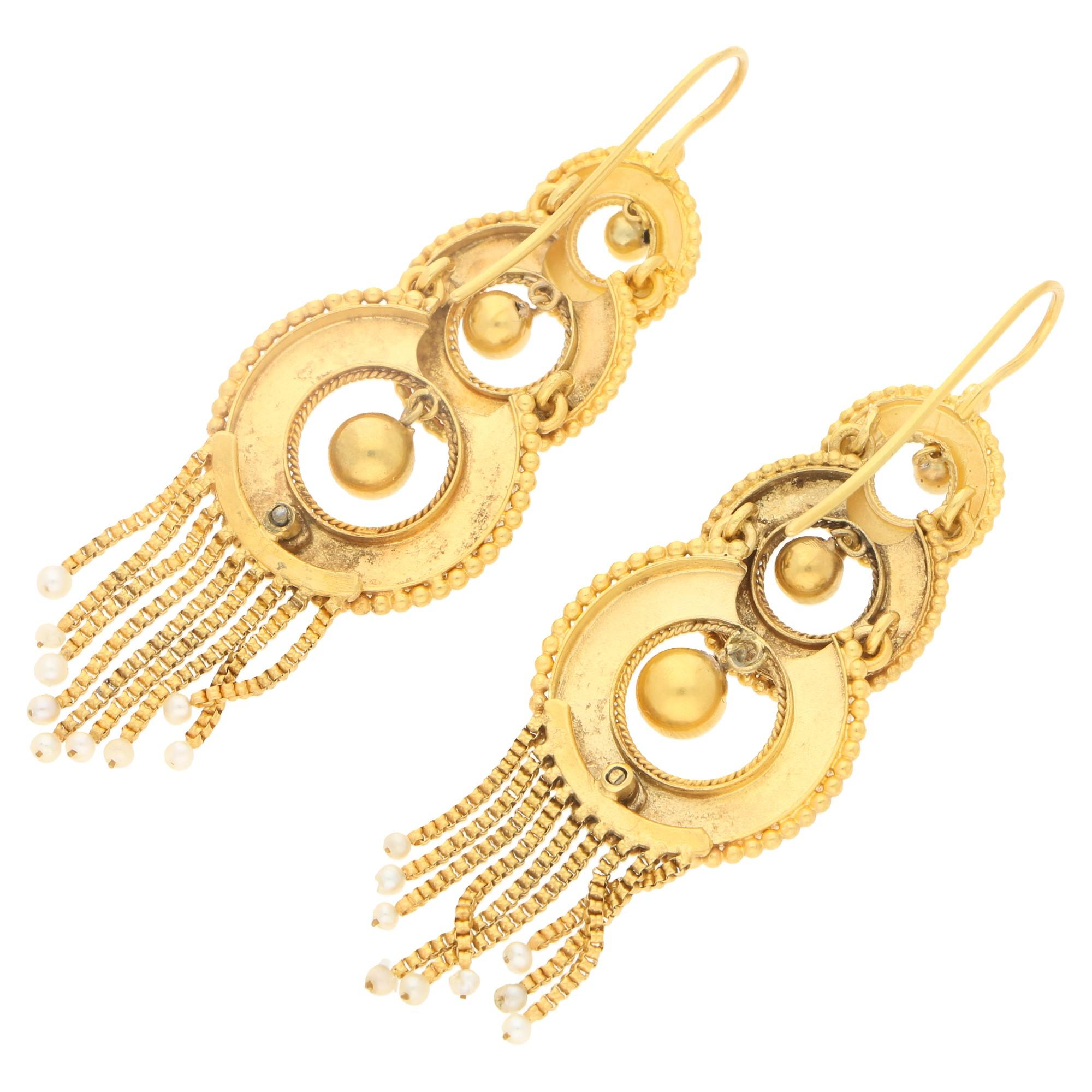 An exquisite pair of Victorian seed pearl tassel ear pendants in yellow gold. A matching pair, each designed as a graduating sequence of three openwork roundels with fine ropework detailing on the inner edge and gold beading on the outer edge, with