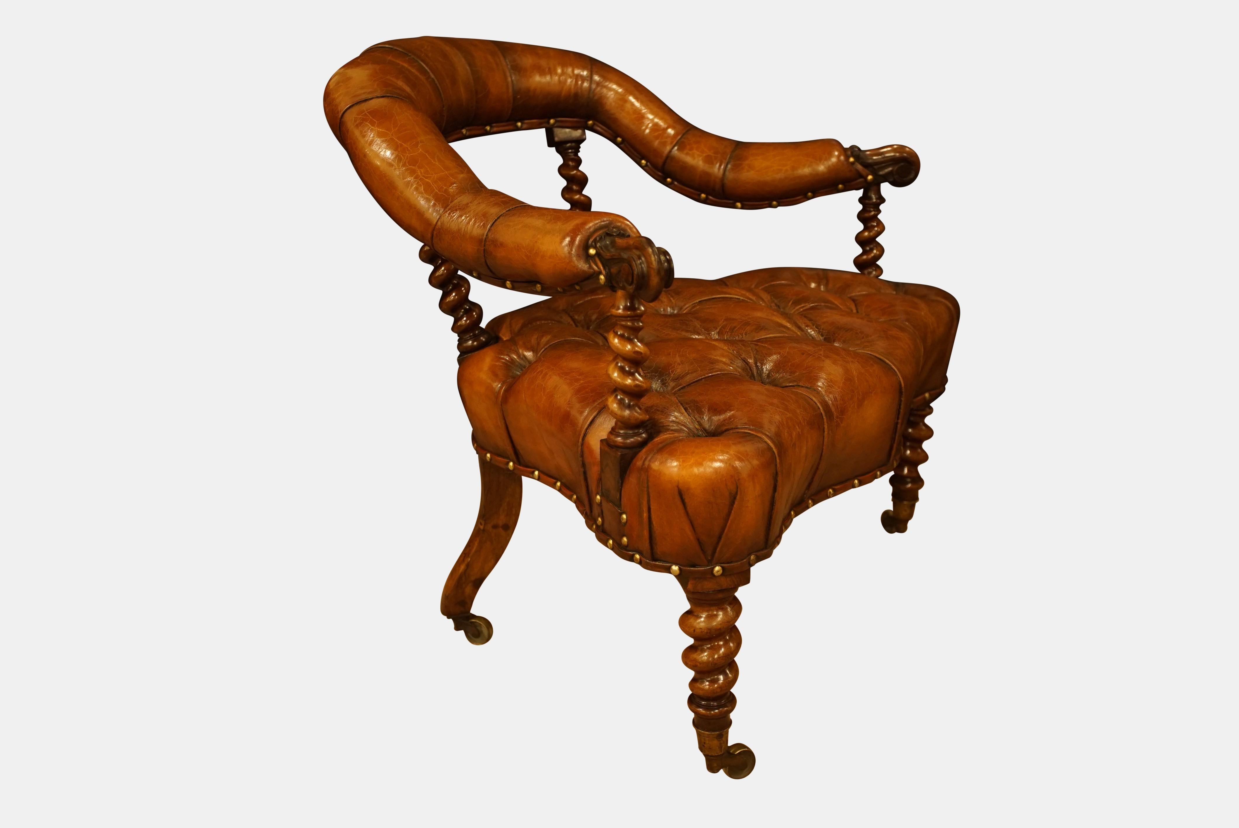 Victorian serpentine rosewood chair, overstuffed back on barley twist supports and scrolled arms.