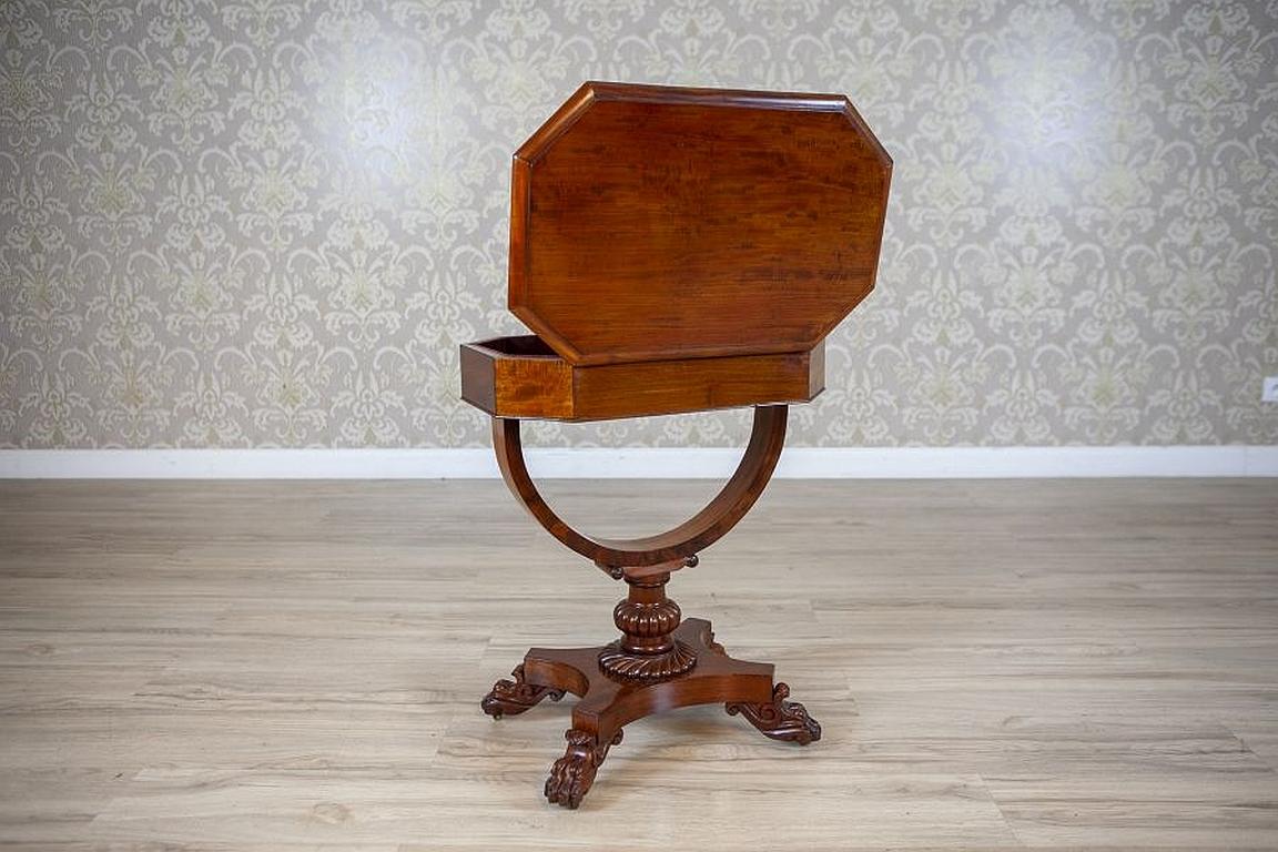Victorian Mahogany Wood and Veneer Sewing Table Circa 1850

We present you a mahogany sewing table from the mid. 19th century.
There is a blank drawer and a storage compartment, opened from the top, with the inside lined with dark claret velvet.
The
