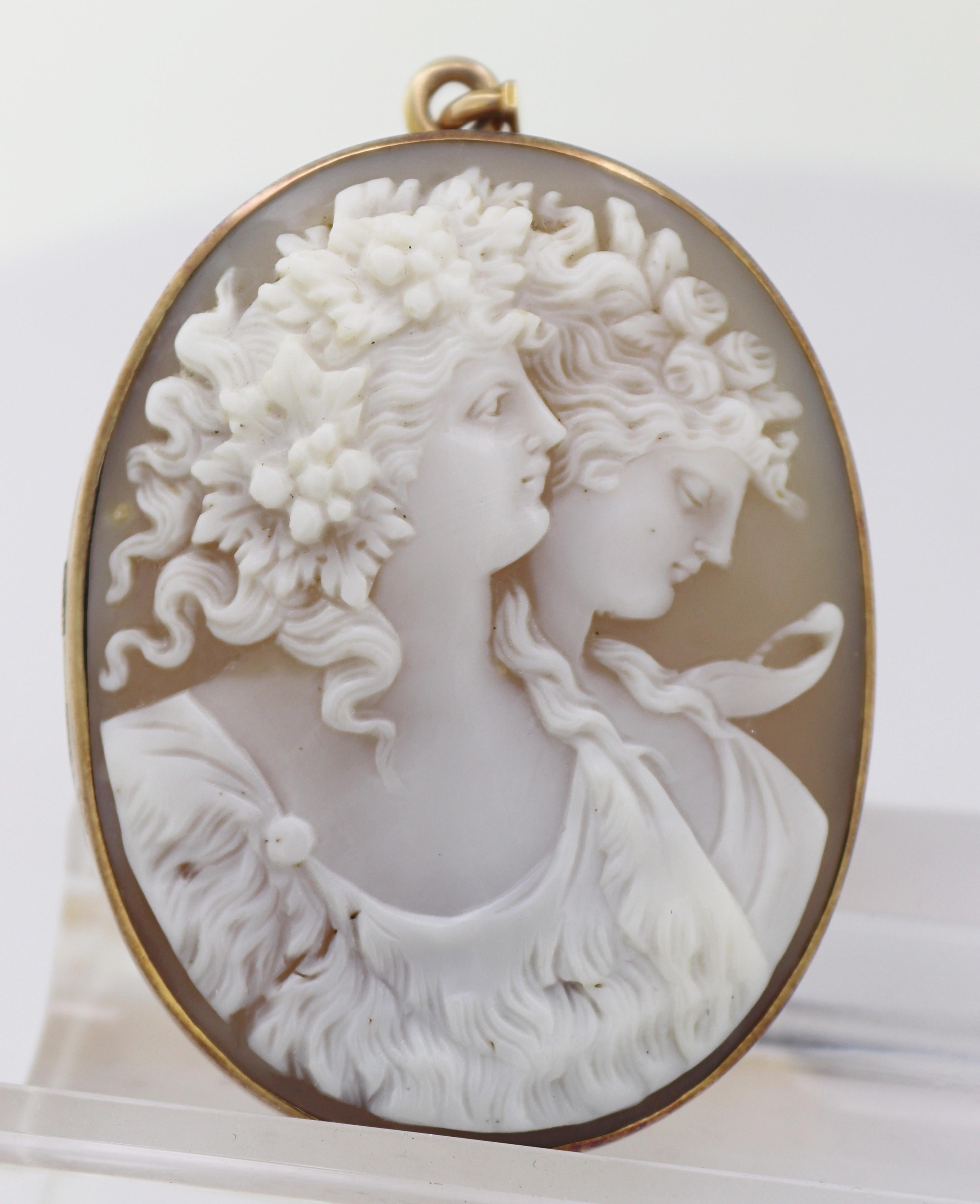 Featuring one carved shell cameo, depicting Bacchus and Ariadne, 48.8 X
38.4 mm, bezel set in a 12k yellow gold hinged locket mounting, opening to
reveal locket compartment and frame, 39 X 28 mm, the back features a
script engraved monogram “LNK”,