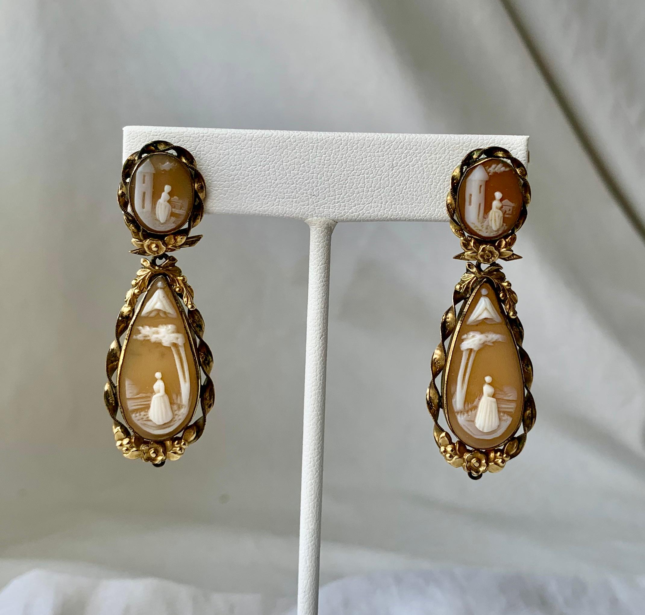 THIS IS AN ABSOLUTELY STUNNING AND VERY RARE PAIR OF VICTORIAN SHELL CAMEO PENDANT EARRINGS SET IN GOLD.  THE STUNNING HAND CARVED SHELL CAMEO EARRINGS ARE VERY EARLY, CIRCA 1850-1870 I BELIEVE.  IT IS VERY RARE TO FIND THESE LONG 2 1/8 INCH CAMEO