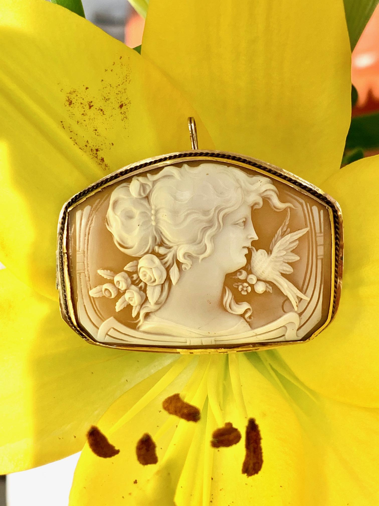 This Victorian shell Cameo features an intricately carved woman and bird.   The frame is 14 karat yellow gold.   I love this era of jewelry because pieces such as this were designed to be worn in more than one way.  For example, this cameo can be