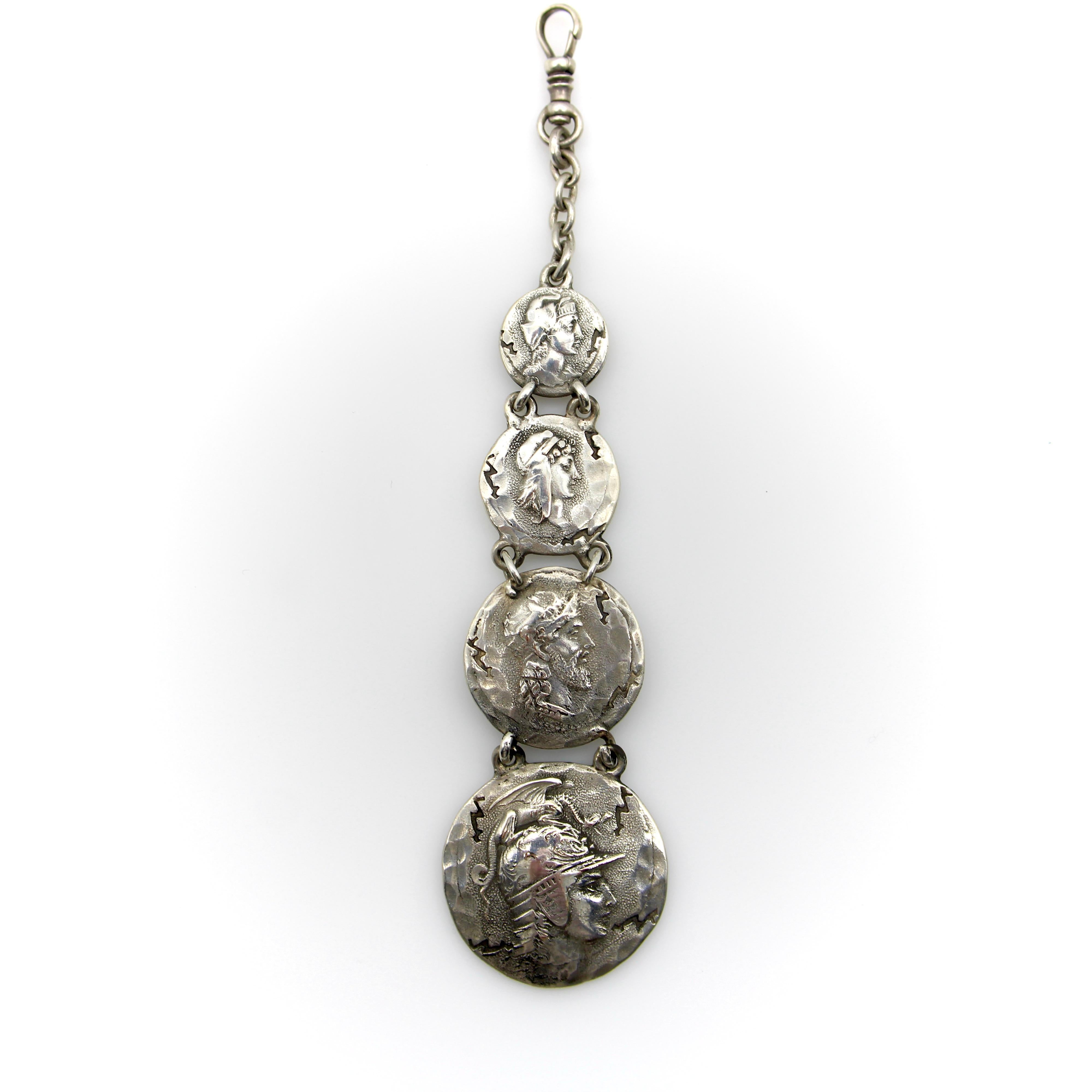 This sterling silver fob features four graduated homeric medallions, dangling from a dog clip. Designed by George Shiebler, circa 1890’s, the piece was originally a watch fob; in contemporary use it makes a dramatic pendant when worn on a chain, or