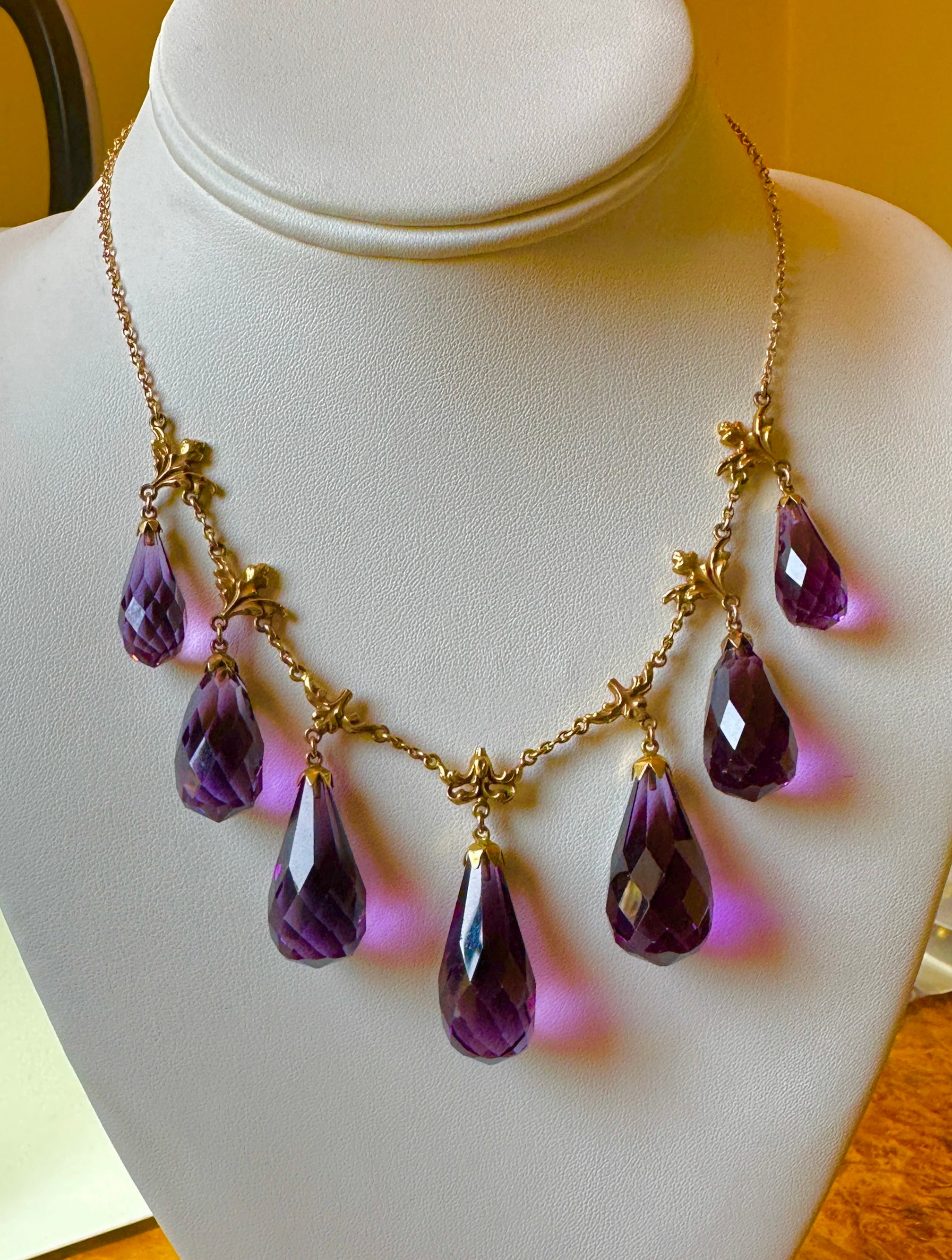 THIS IS A STUNNING ANTIQUE VICTORIAN - BELLE EPOQUE NECKLACE WITH THE MOST GORGEOUS LARGE NATURAL GRADUATED PEAR SHAPE BRIOLETTE FACETED SIBERIAN AMETHYST GEMS SET IN A WONDERFUL PENDANT FRINGE DESIGN WITH ACANTHUS FORM TERMINALS IN 14 KARAT