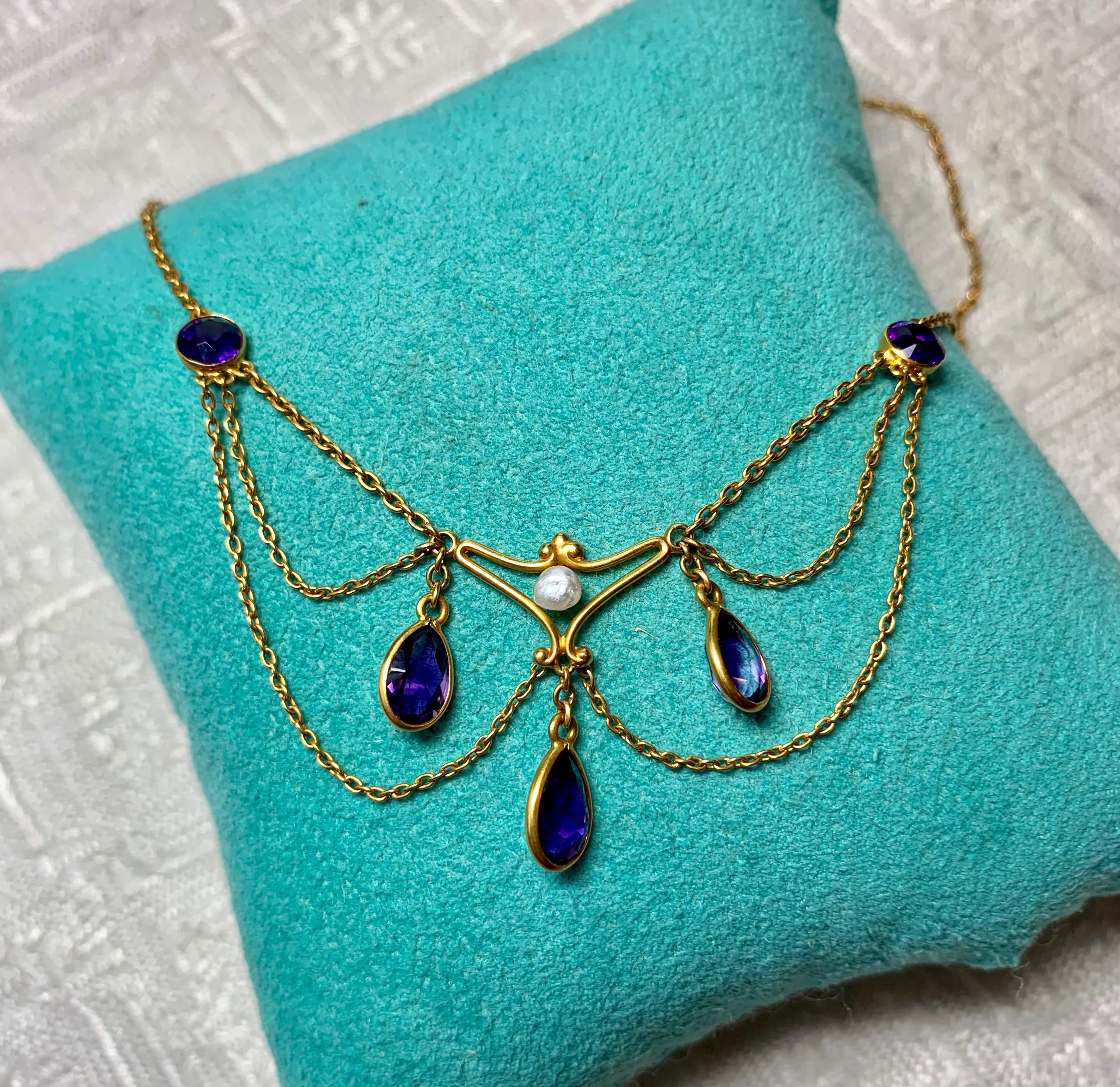 Indulge in a stunning Antique Victorian - Edwardian Festoon Necklace with the most gorgeous gem quality Siberian Amethysts set in beautiful 14 Karat Gold with a Baroque Pearl accent.  The antique necklace dates to circa 1870-1910.  The Amethysts are