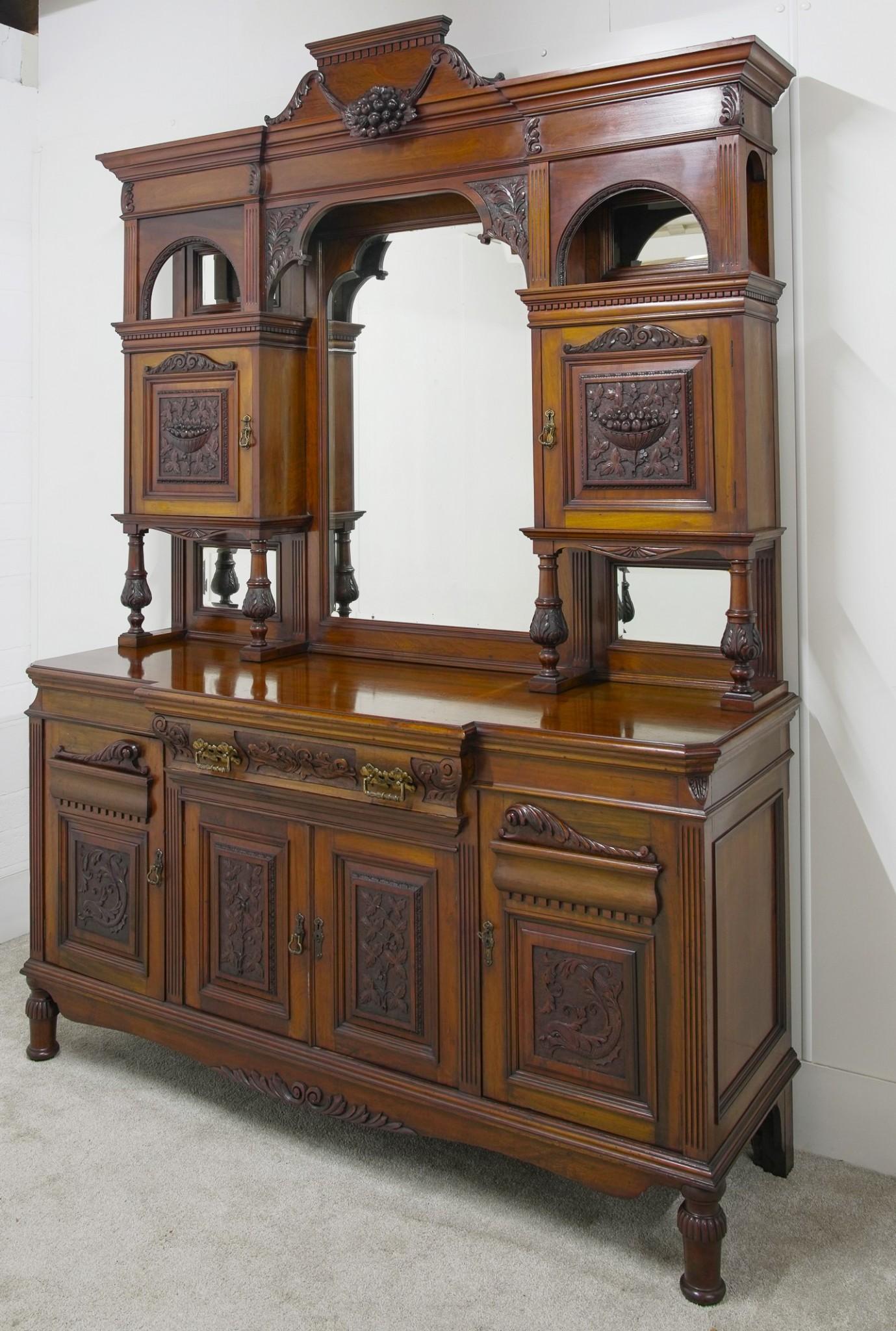 Gorgeous Victorian sideboard in mahogany
Features intricate carved details on many surfaces including elaborate door panels
Further carved motifs include floral garlands, leaves and fruit bowls
Piece features a mirrored back which would be a great
