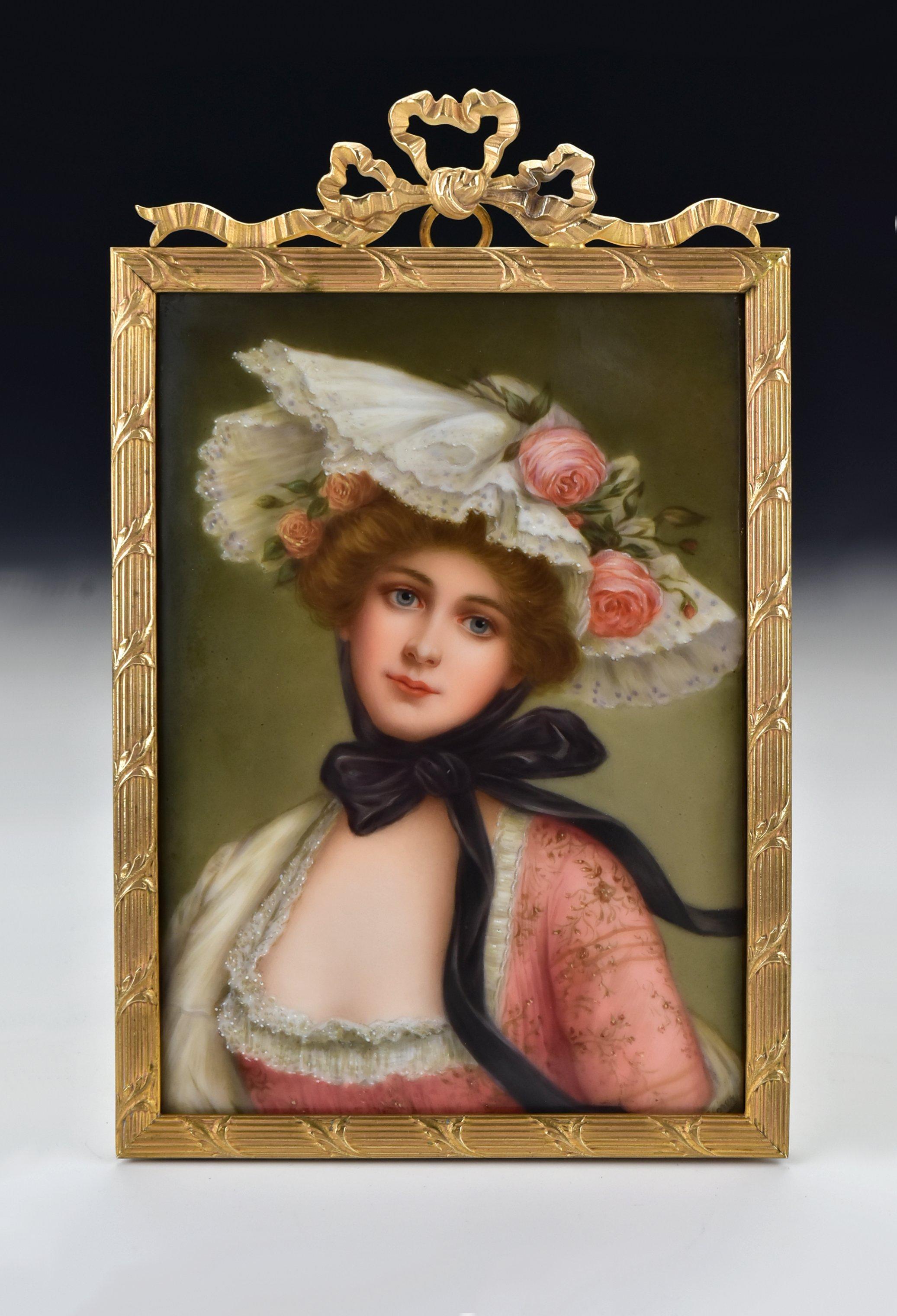 Description: Hand painted portrait on porcelain depicting a young woman with a large hat, artist signed Wagner on the front and marked on the back as shown, set in a fancy bronze frame.

Age: Late 19th century

Size: The painting alone measures