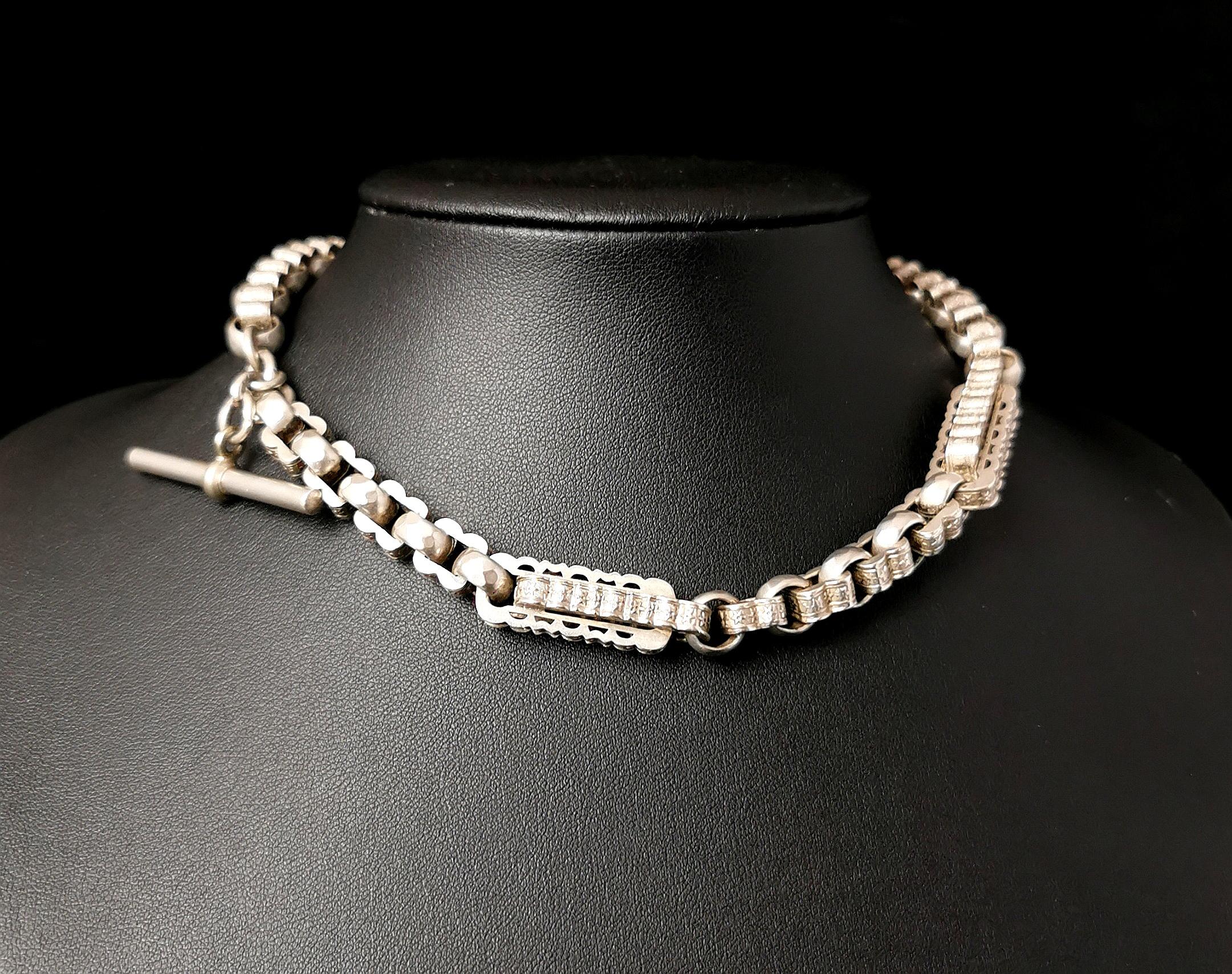 A heavy and chunky antique Victorian era, fancy link silver Albert chain.

Nice chunky engraved and embossed bar links intercepted with big faceted rolo links and further smaller embossed links.

The chain is made from sterling silver and is