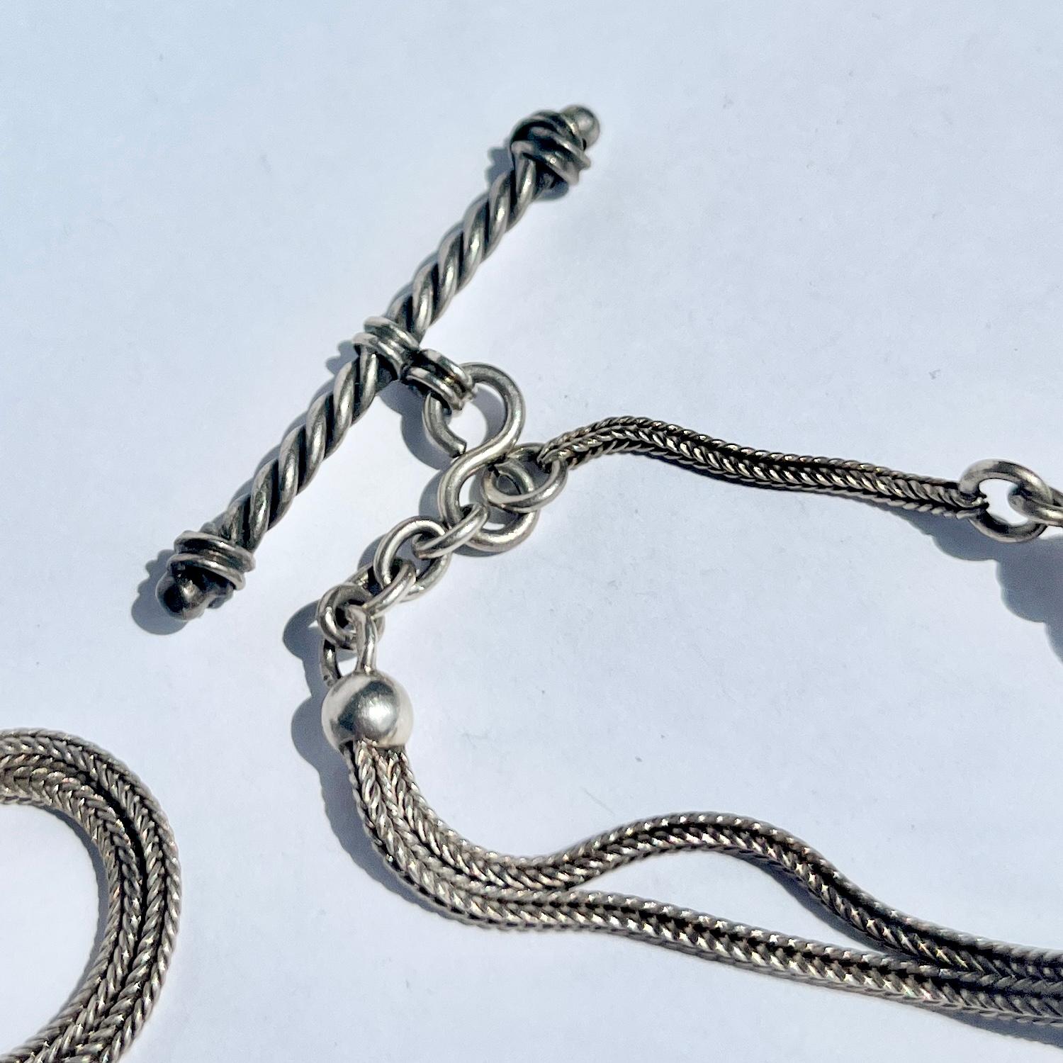 An Albert chain is an essential in any gents wardrobe. This particular Albert  is made up of snake chain. There is a dog clip at one end and a t-bar at the other.  

Length: 31cm

Weight: 22g
