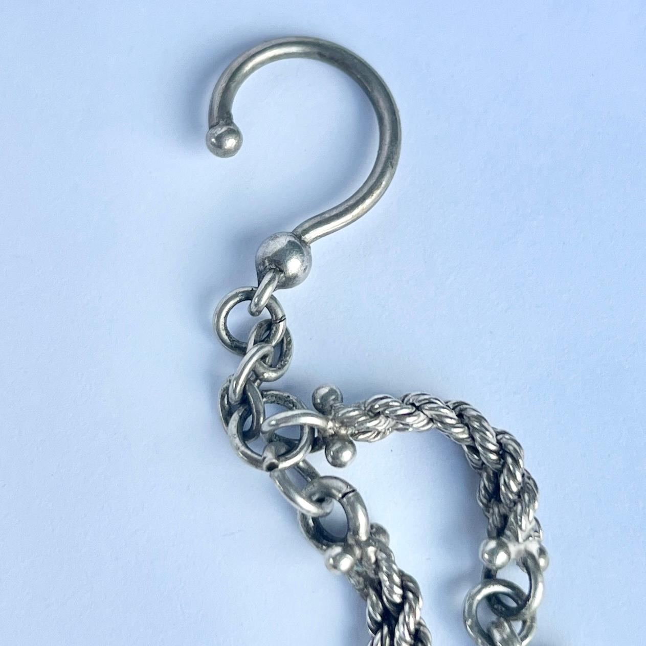 An Albert chain is an essential in any gents wardrobe. This particular Albert  is made up of chunky top twist chain. There is a dog clip at one end and it holds a hook.  

Length: 28cm (inc tassel)

Weight: 16.9g