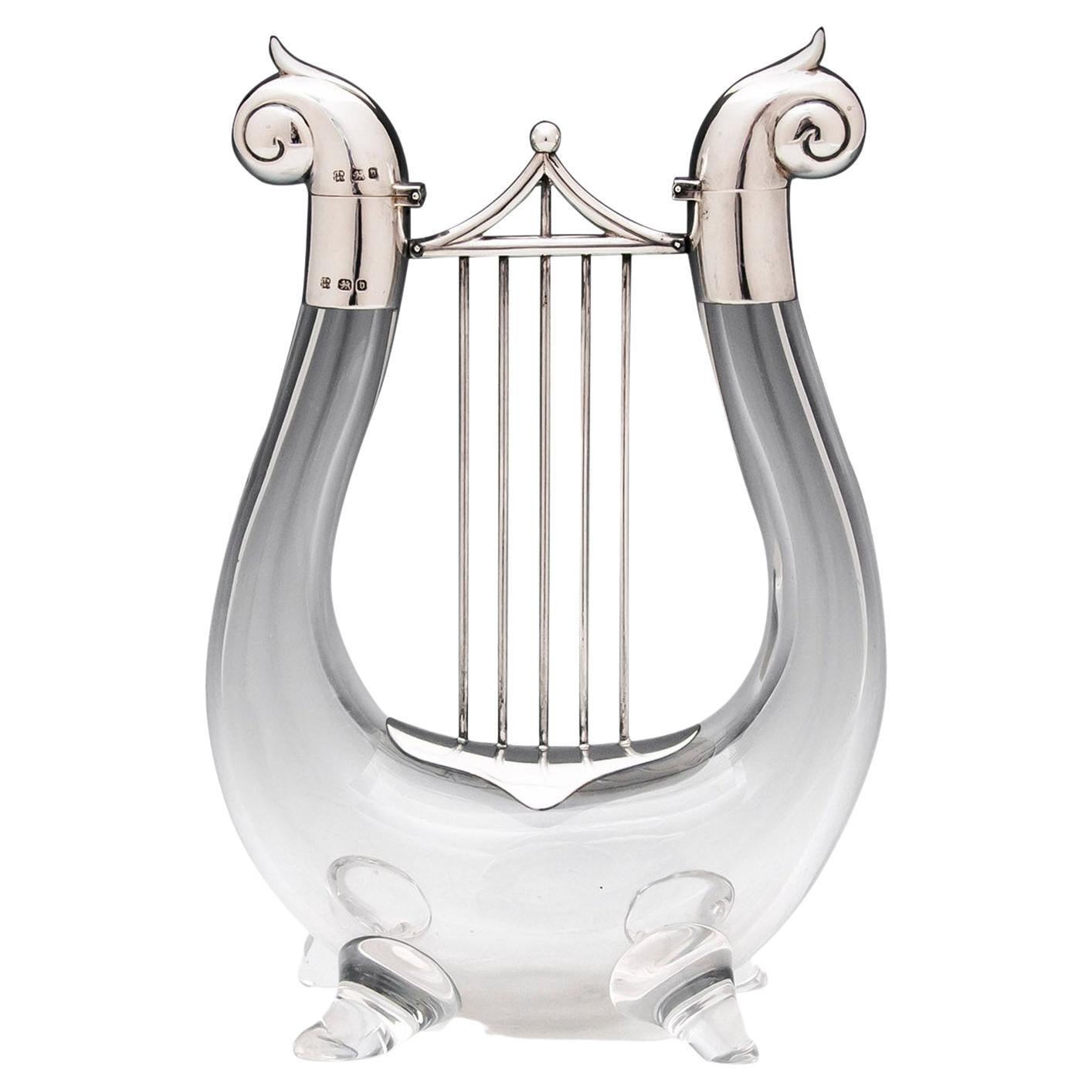 With Sterling Silver Mounts

From our Decanter collection, we are delighted to offer this very unusual late 19th-century Novelty Decanter. The Decanter modelled as a classical Lyre with glass body, Sterling Silver scrolling mounts and crossbar. The