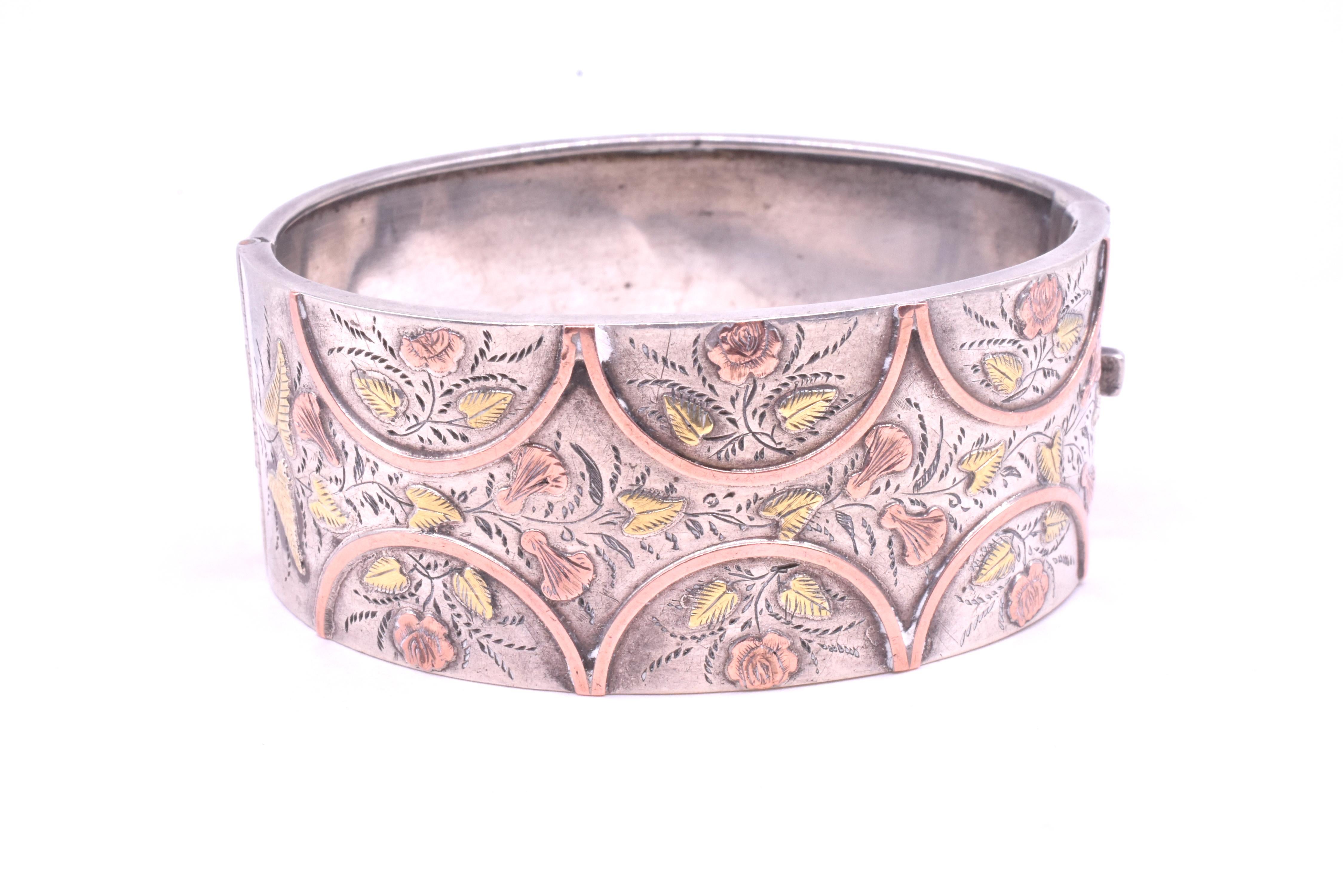 Wonderful silver cuff with two color gold leaves, roses and lilies accented with gold arches. Silver cuffs like this one were made to appeal to all classes of society, including the 
