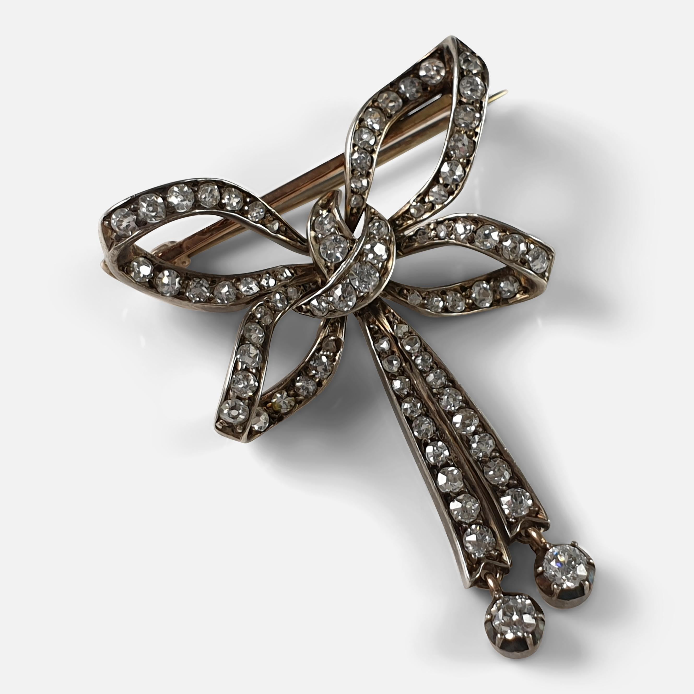A late Victorian diamond bow brooch set with 78 diamonds totaling approximately 1.40cts. The brooch is crafted in silver at the front and backed in 9 karat gold, typical of the period's style.

 • Period: Early 20th century.
 • Engraving: None.
 •