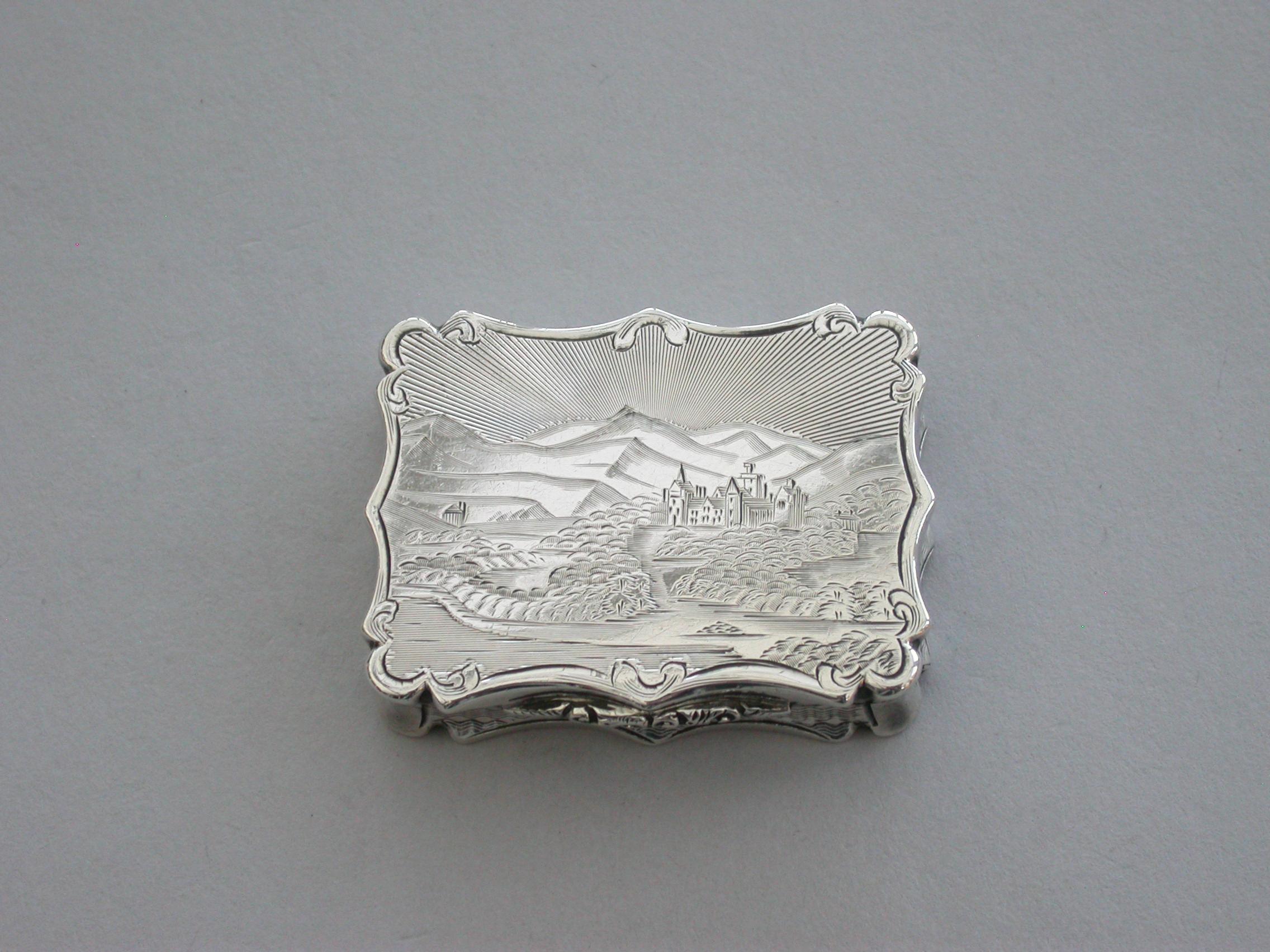A rare Victorian silver Vinaigrette of shaped rectangular form, the base and sides with engine turned decoration and a vacant cartouche. The lid engraved with a scene depicting Old Balmoral castle and lands with small buildings against hills and a