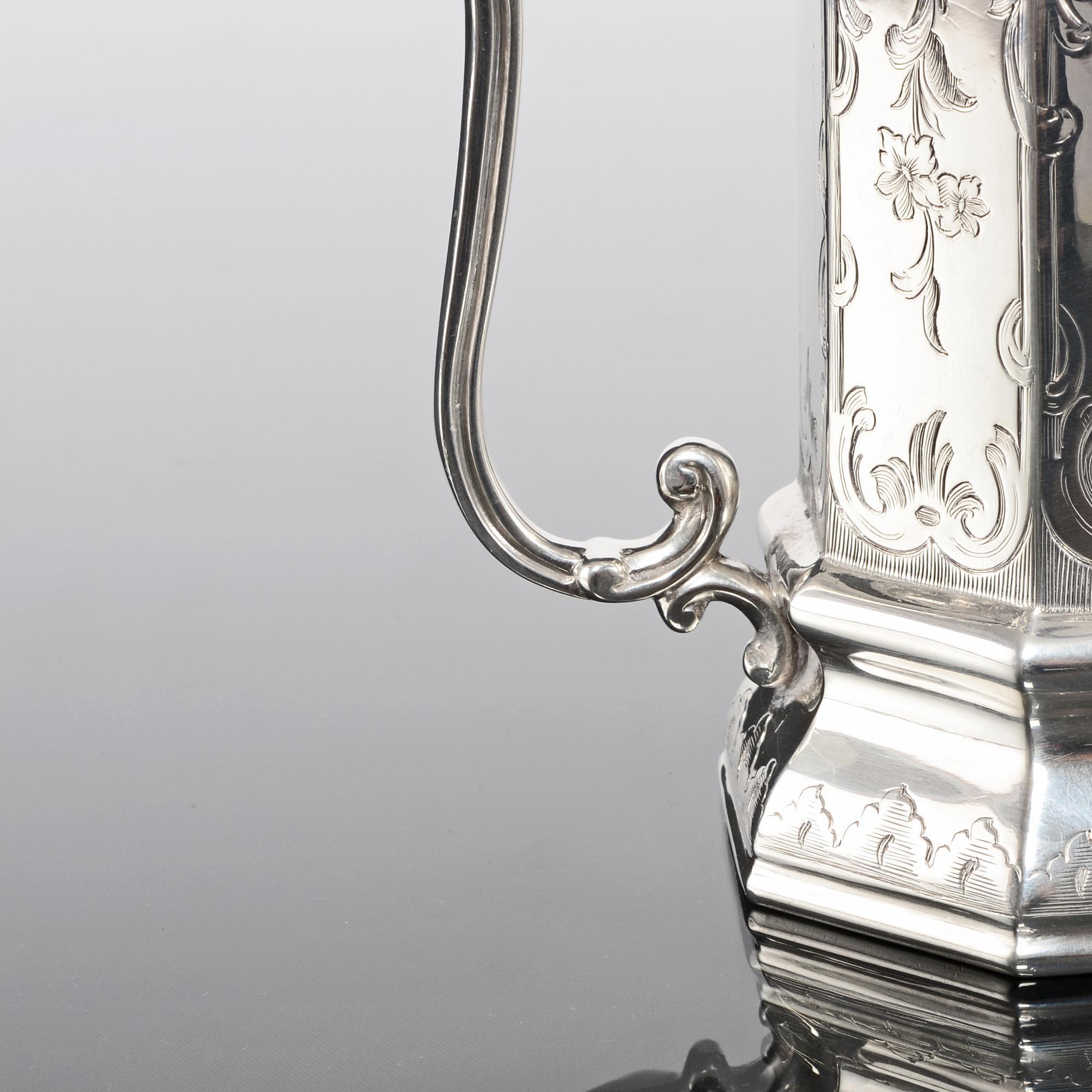 A lovely quality Victorian silver christening cup. The gothic style octagonal body sits on a flared base and both are finely hand-engraved with floral detail within scroll bordered panels and the cast handle also has scroll features. The interior is