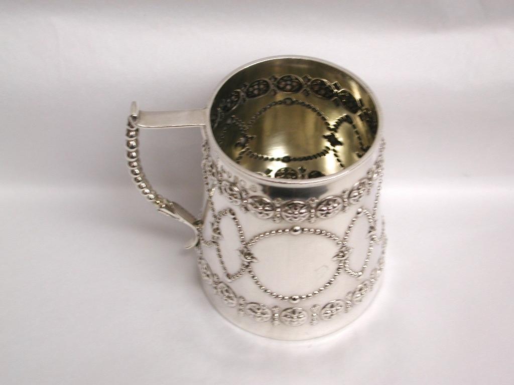 Victorian silver christening cup made by Robert Hennell.
Very nice Gothic decoration which is very typical of this maker.