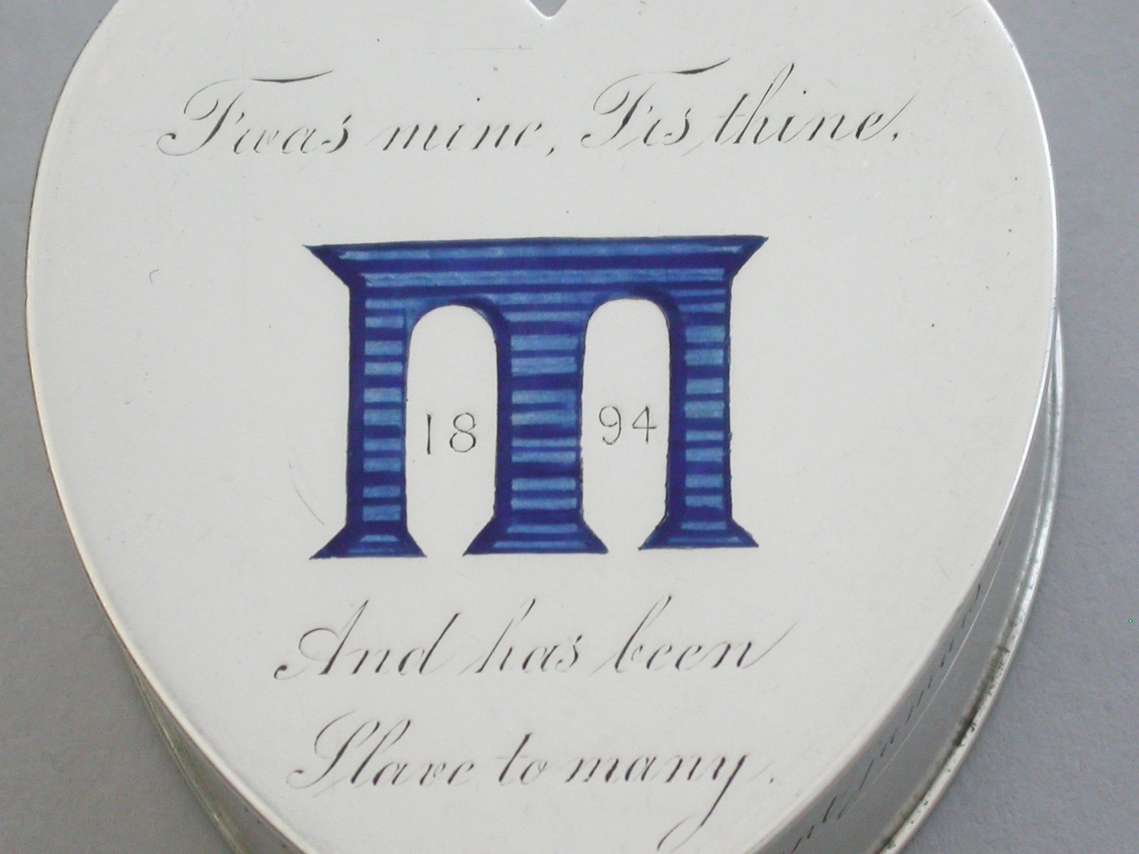 A good quality Victorian silver and enamel heart shaped pill box, the cover set with a blue enamel viaduct and the date 1894 between an engraved quote from Othello by William Shakespeare - 