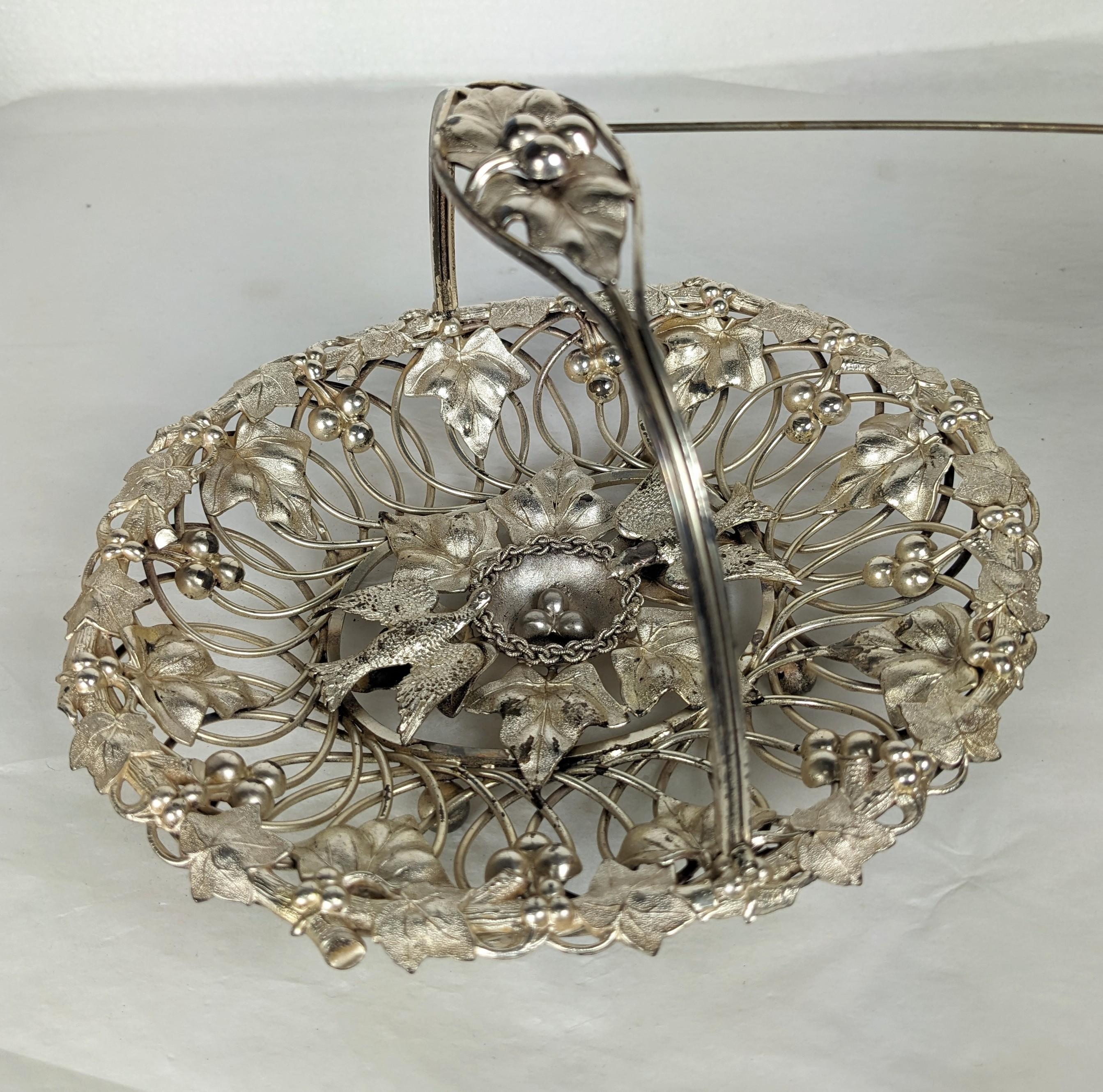 Charming Figural Victorian Silver Plated Brides Basket from the late 19th Century. Ornate design with doves nesting around their eggs with elaborate leaf, berry and wire work border. 1870s USA.