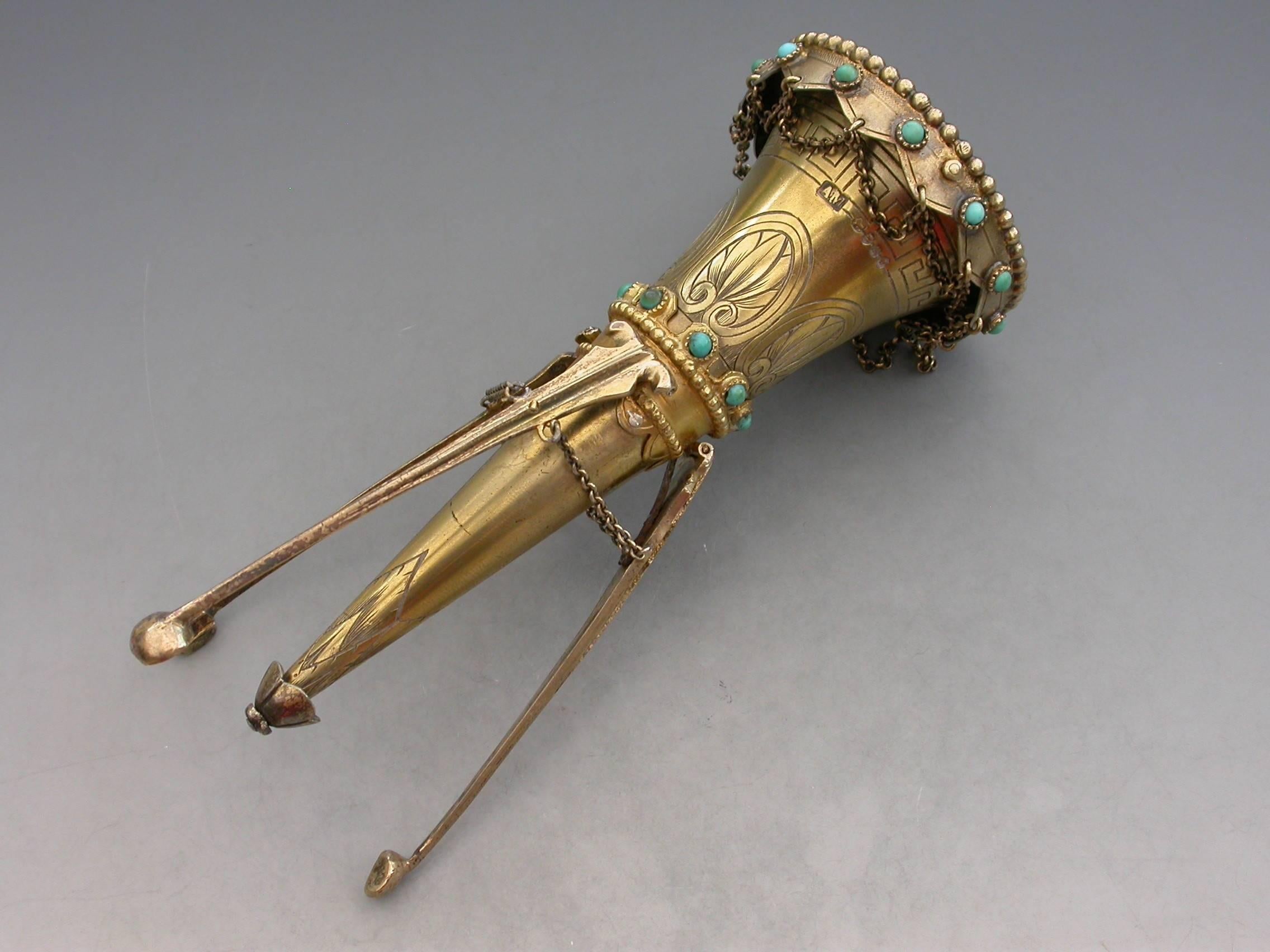 A good quality Victorian silver gilt posy holder of trumpet shape with beaded rims, the body engraved with a band of anthemions, highlighted with two bands of turquoise beads and chain swags. The three sprung legs retained by a sprung petal shaped