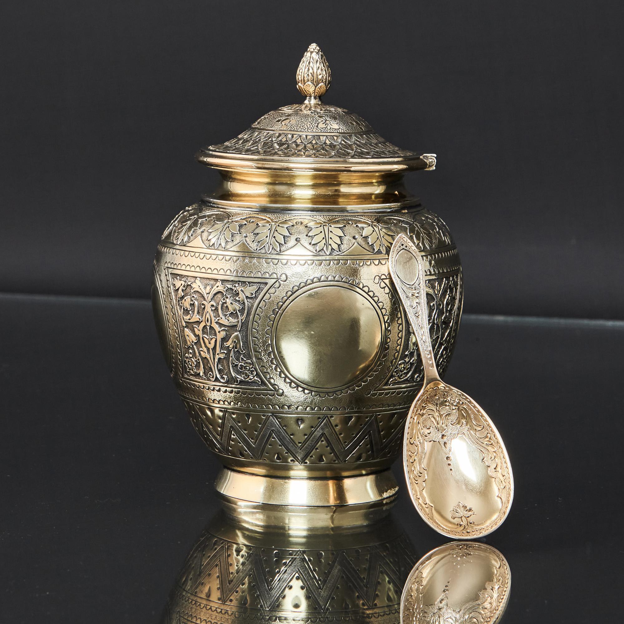 Antique silver-gilt tea caddy with matching caddy spoon, each of exceptionally good quality and finely chased to reflect Moorish design that was so popular in the Victorian era. The caddy is hand chased with decorations that reflect that Moorish