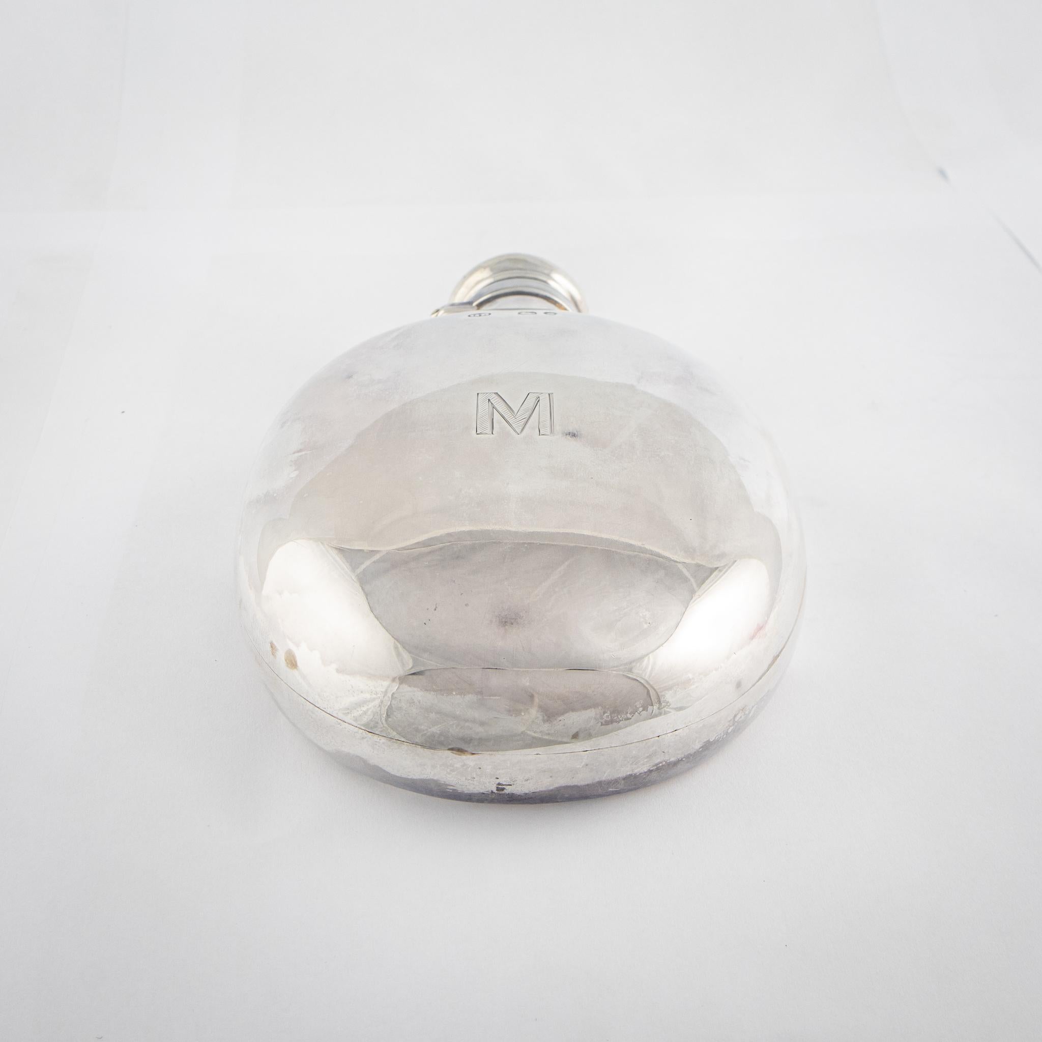 This wonderful Victorian silver hip flask, crafted by the silversmith George Brace and hallmarked for London, exudes quality and craftsmanship. Its oval form, meticulously designed, offers a pleasingly ergonomic grip. The bayonet fitting lid ensures