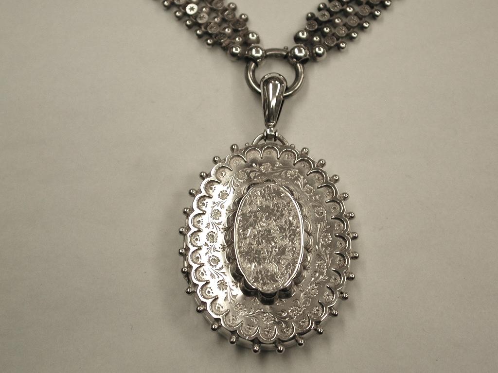 Victorian silver locket and collar, made by Hepburn and Wilcox, Birmingham, 1881
Beautifully decorated with floral engraving with beaded surround on the locket.
The collar has double starred and triple beaded decoration.

 