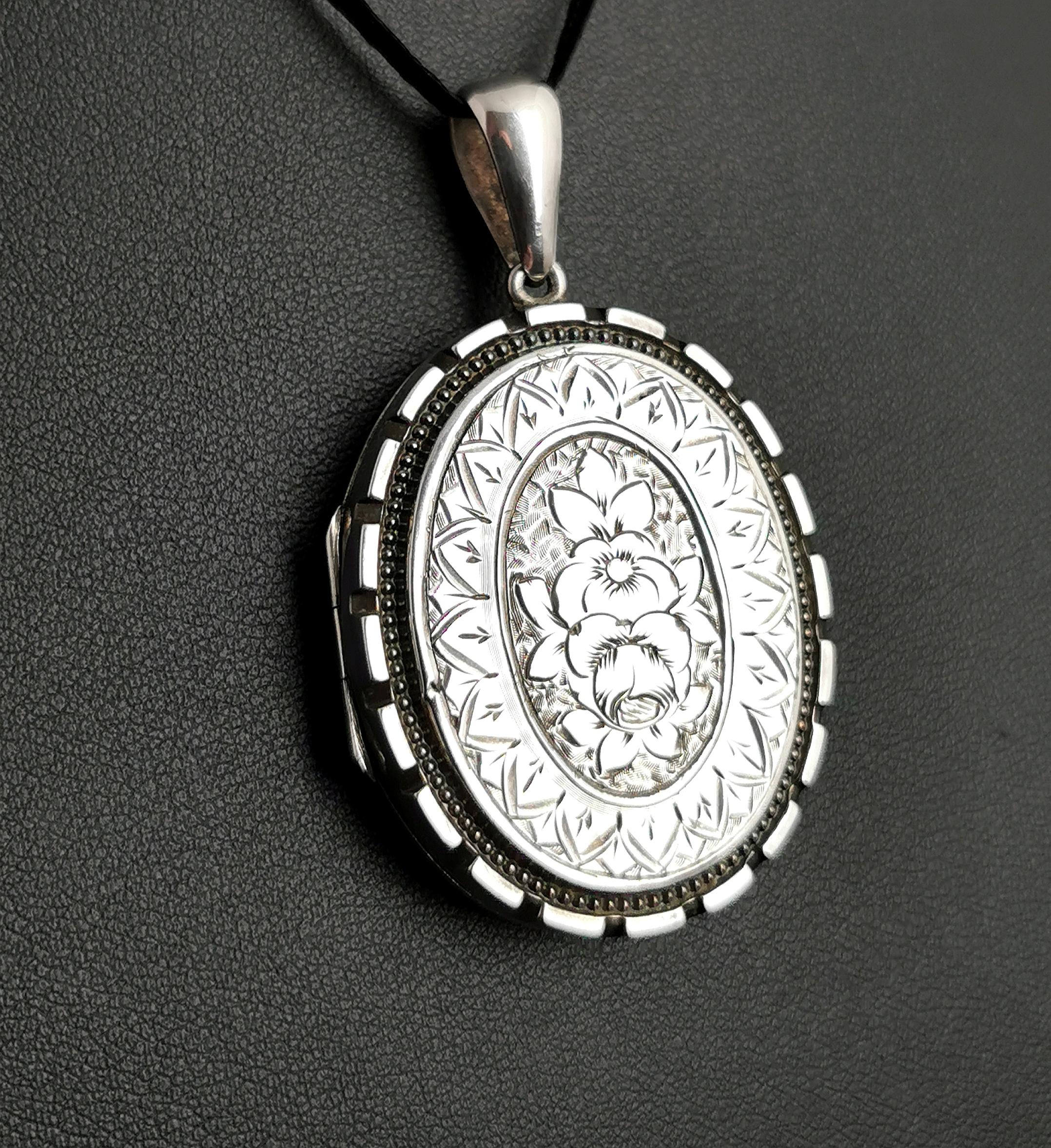 A beautiful antique Victorian sterling silver locket pendant.

It is engraved all over with ivy leaves on the reverse, a heavily symbolic image in Victorian jewellery, amongst other things symbolising everlasting love or memory, the evergreen.

The