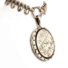 Victorian Silver Locket with Bird and Floral Detail