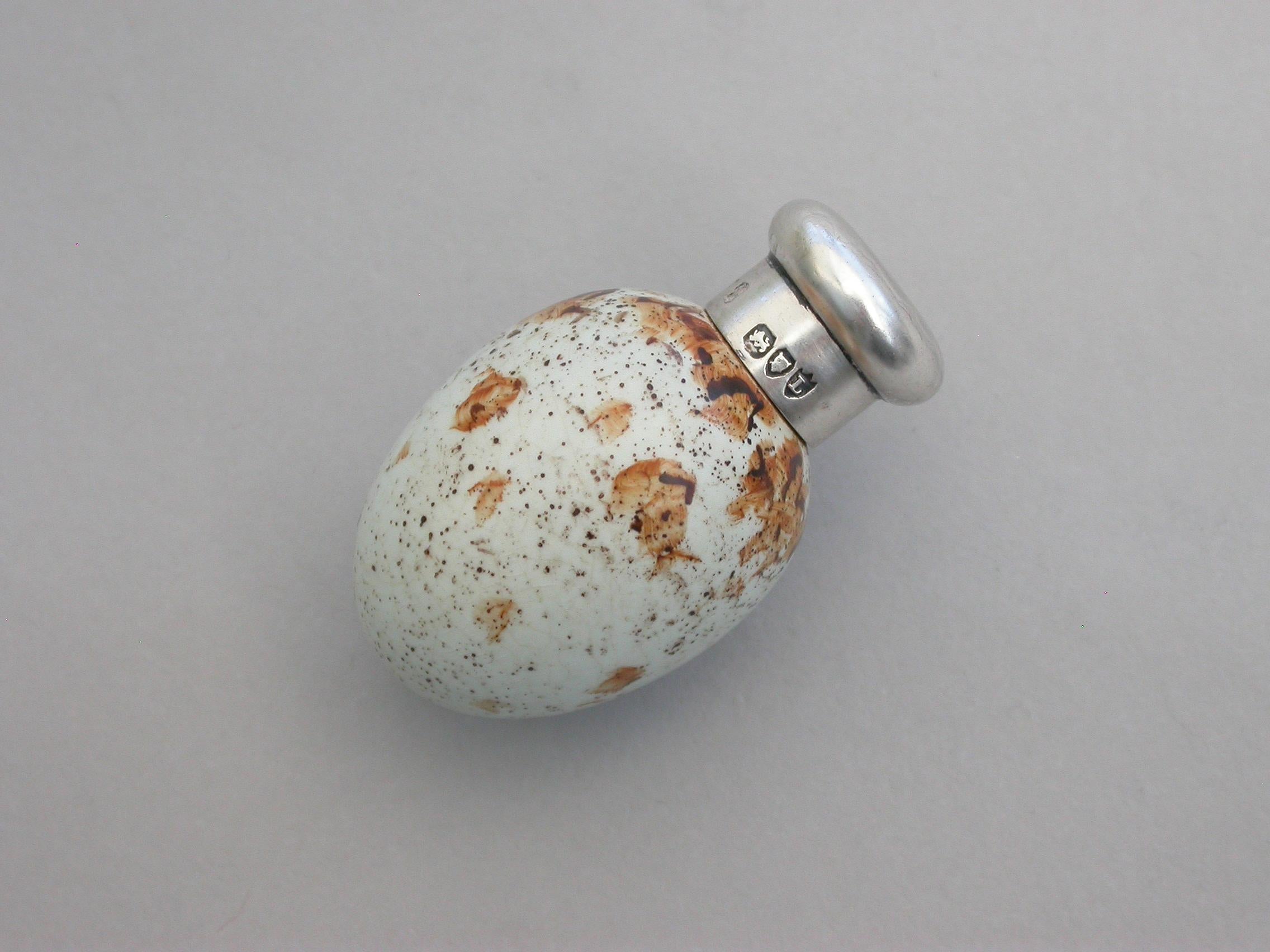 A good Victorian novelty silver and MacIntyre ceramic Scent Bottle made in the form of a Marsh Warblers egg with screw-off top.

The egg stamped with a registered design number: 20772

By Sampson Mordan, London, 1886.