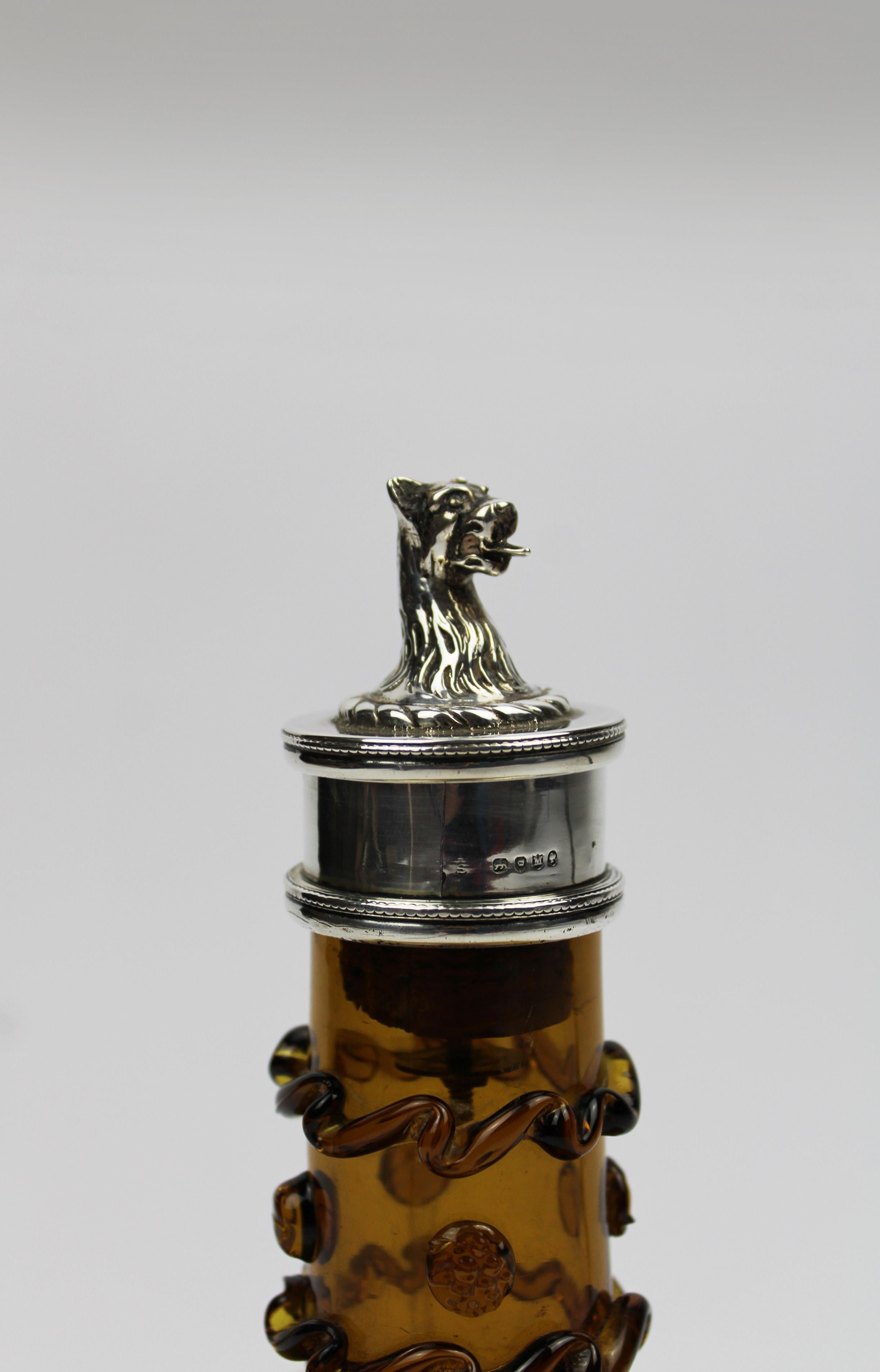 Discover the charm of Victorian elegance with this exquisite amber-colored, globular decanter, mounted in silver and crowned with a striking sterling silver lion stopper. Crafted by Whitefriars Glass and fully hallmarked in London in 1898, this