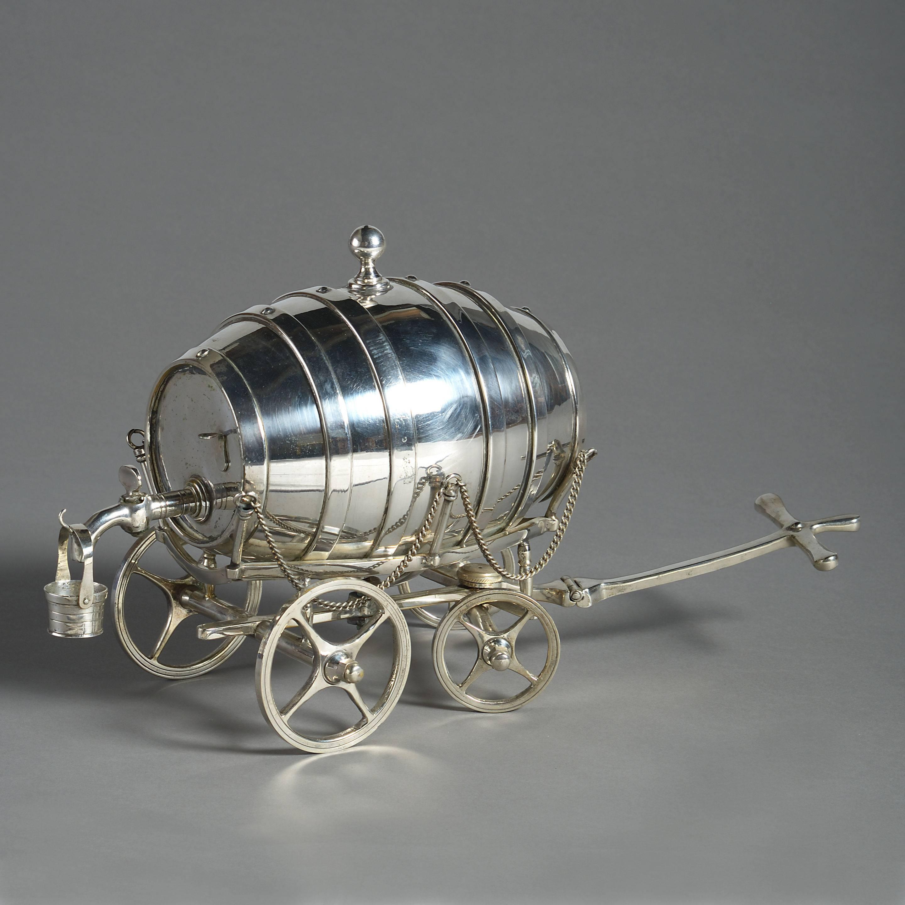 A rare late 19th century novelty silver plated spirit barrel, set upon a carriage and retaining the original measure bucket.