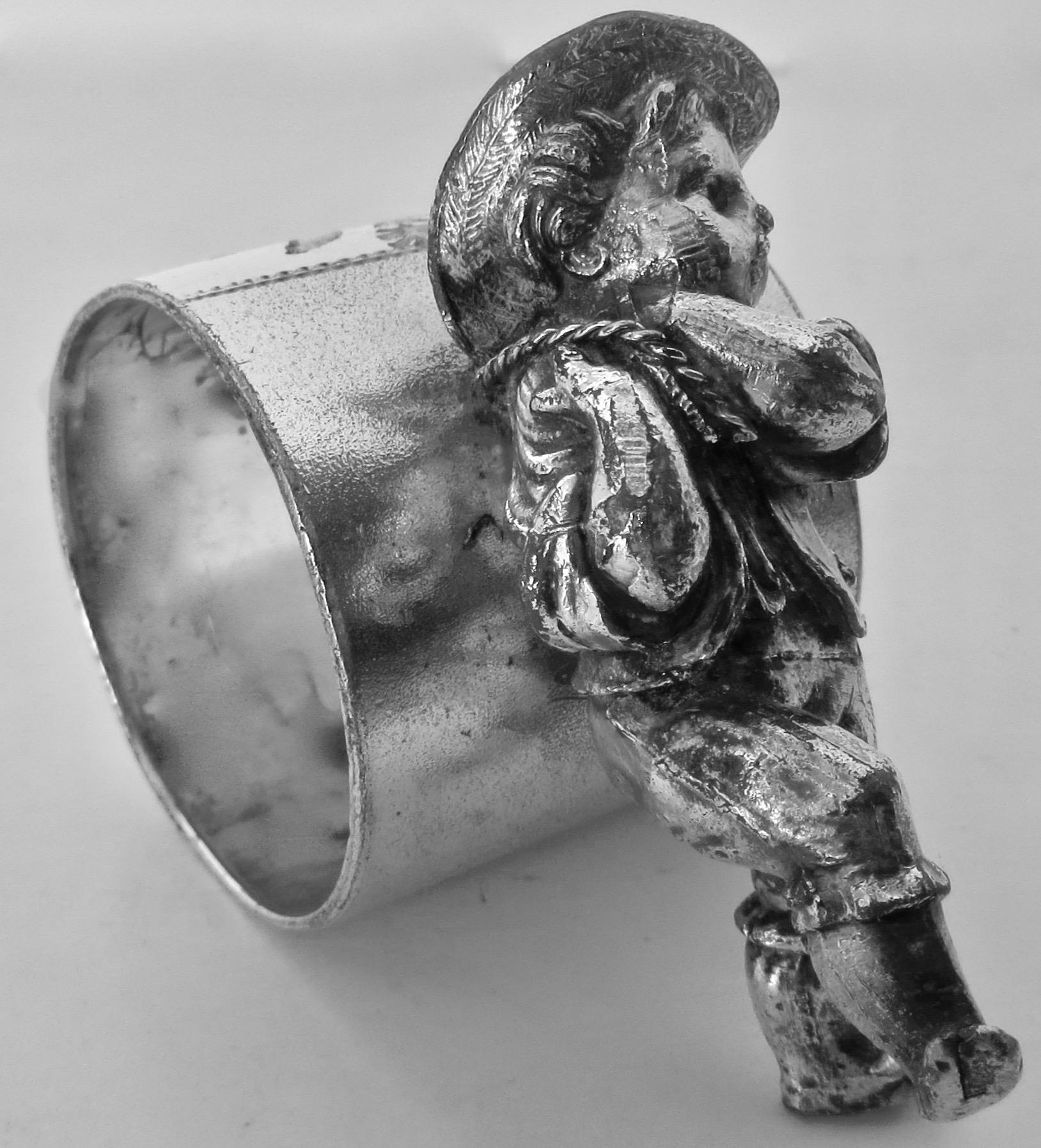 Though unmarked, this napkin ring was most certainly made by The Meriden Britannia Co. and came in two versions; one with a platform beneath the boy; this example has the young boy resting one foot on the ground pulling on the napkin ring. It is