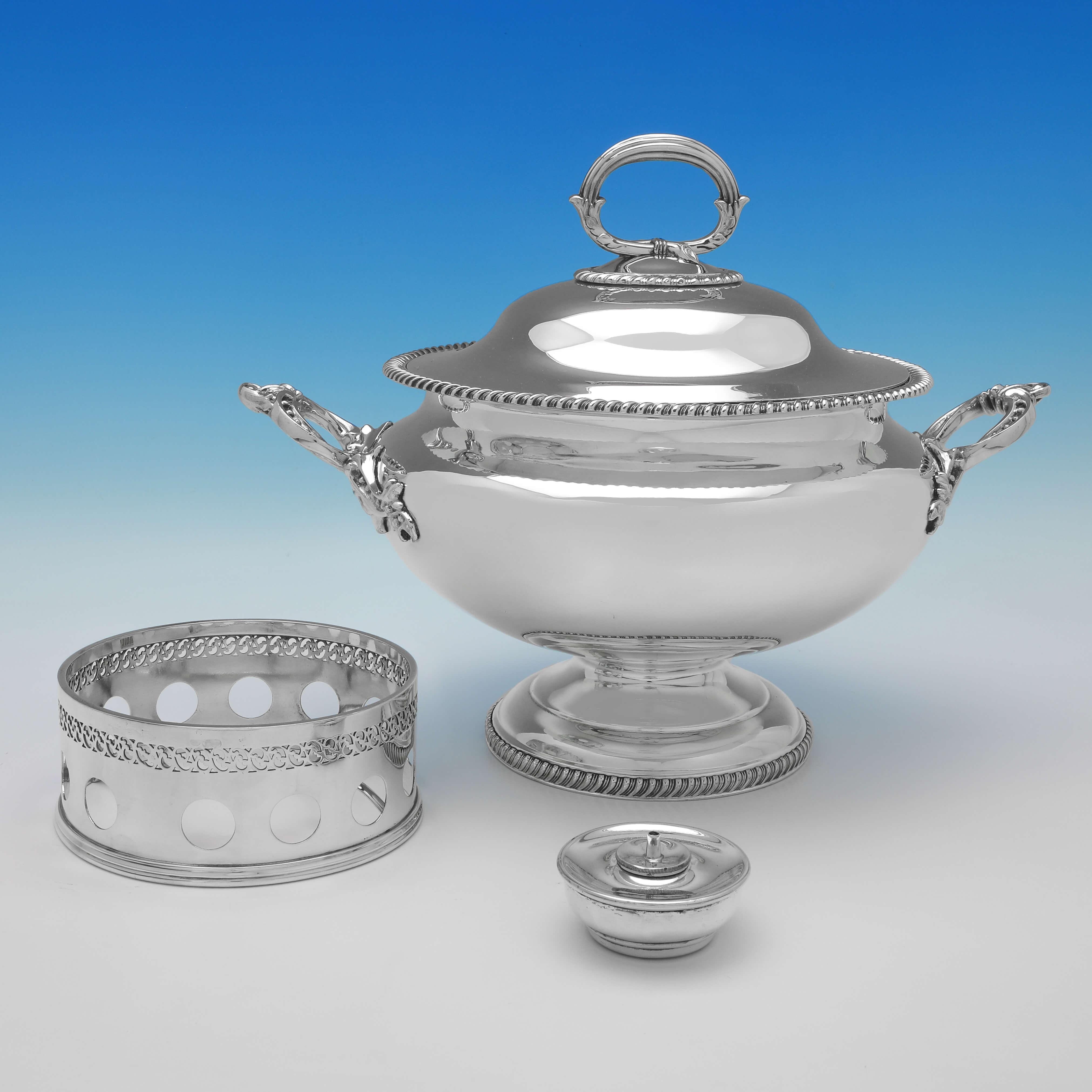 Made in London circa 1880, this handsome, Antique Silver Plate Soup Tureen, stands on a removable base with a heater to keep the soup warm. 

The soup tureen measures 15
