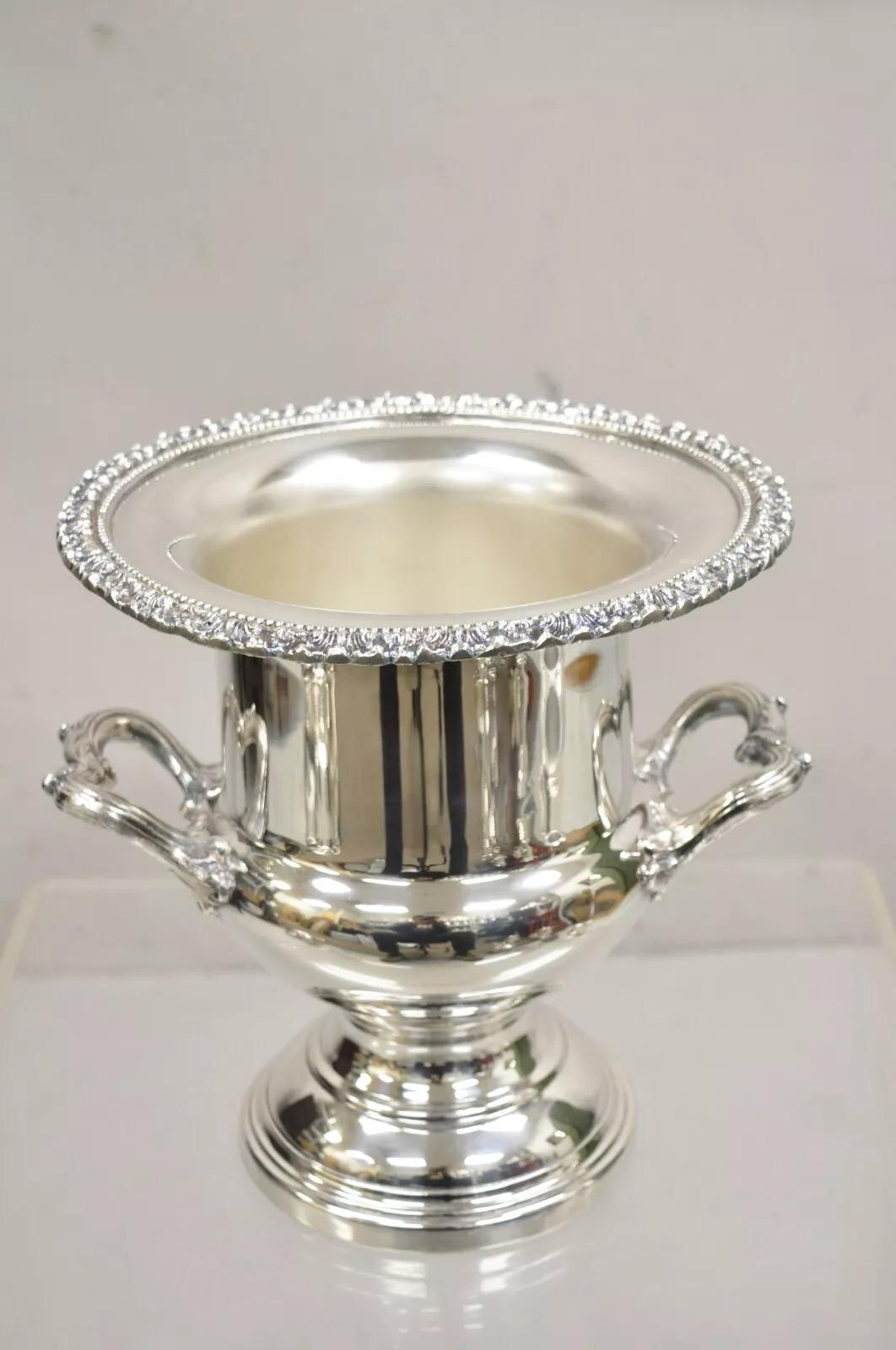 Victorian Silver Plated Twin Branch Handle Trophy Cup Champagne Ice Bucket With Ornate Floral Rim and Nice Heavy Construction. Circa Mid 20th Century. Measurements: 10