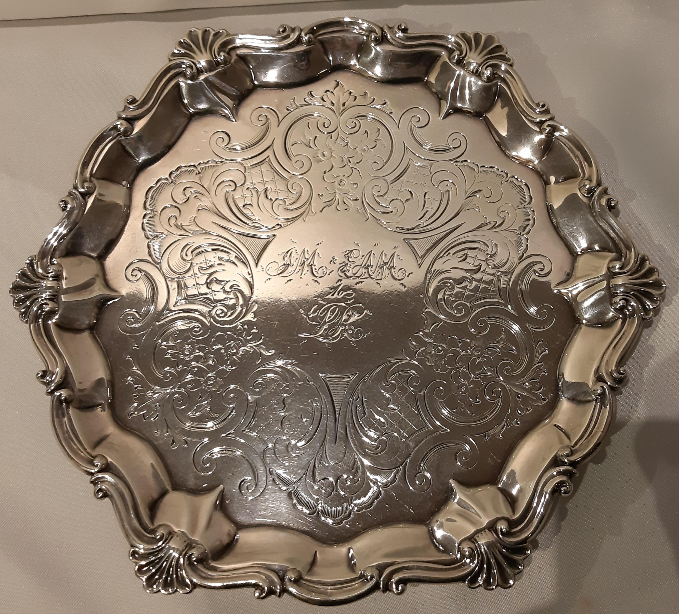 Victorian silver salver supported by feet with punches, London 1855. In excellent condition free from previous breakages or restorations and beautifully and completely chiseled in the large central reserve.