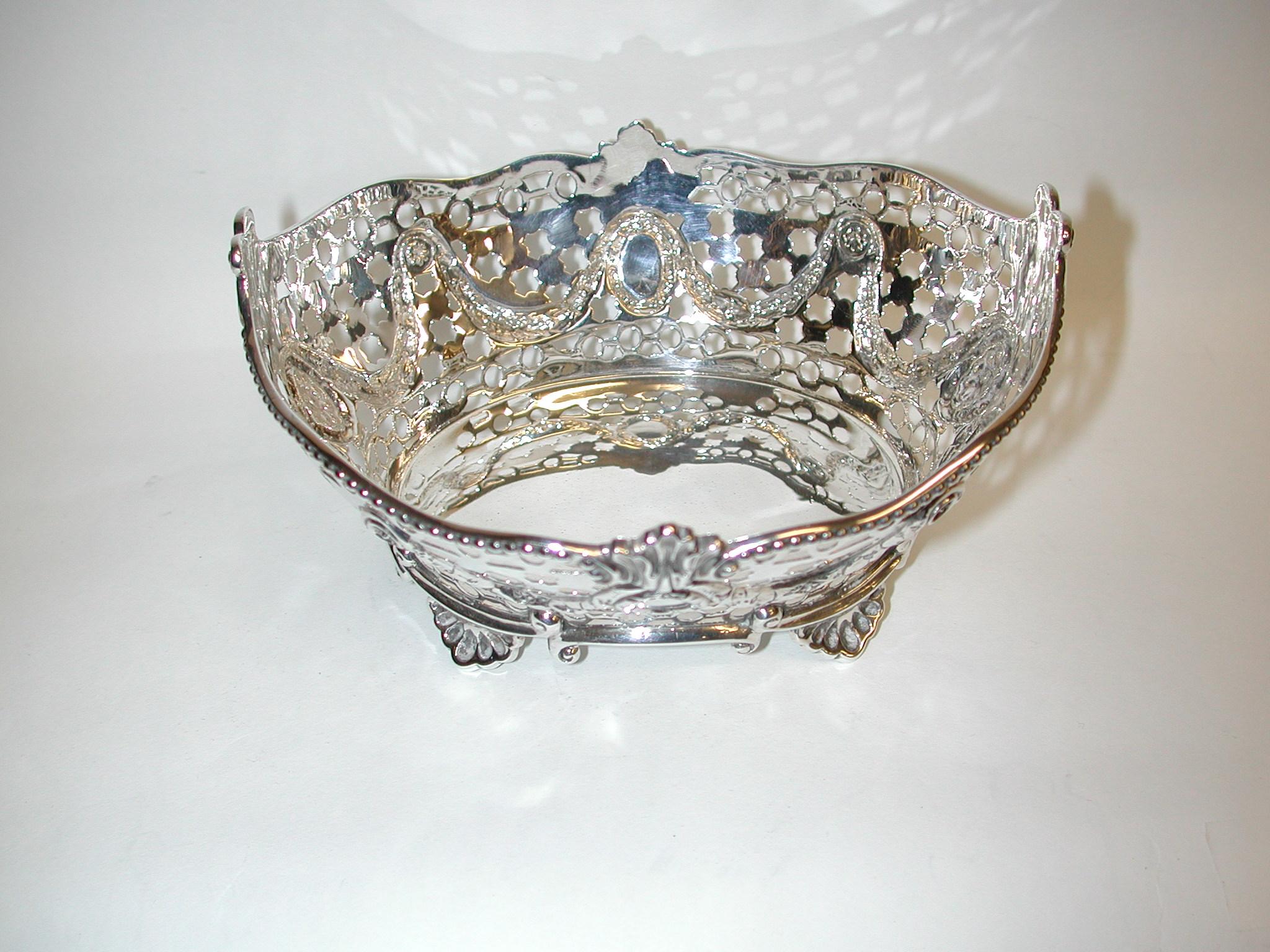 Victorian silver sweet dish, dated 1898, Assayed in London, Charles Stuart Harris
Beautiful silver sweet basket with hand-piercing and cast embossed borders.
   