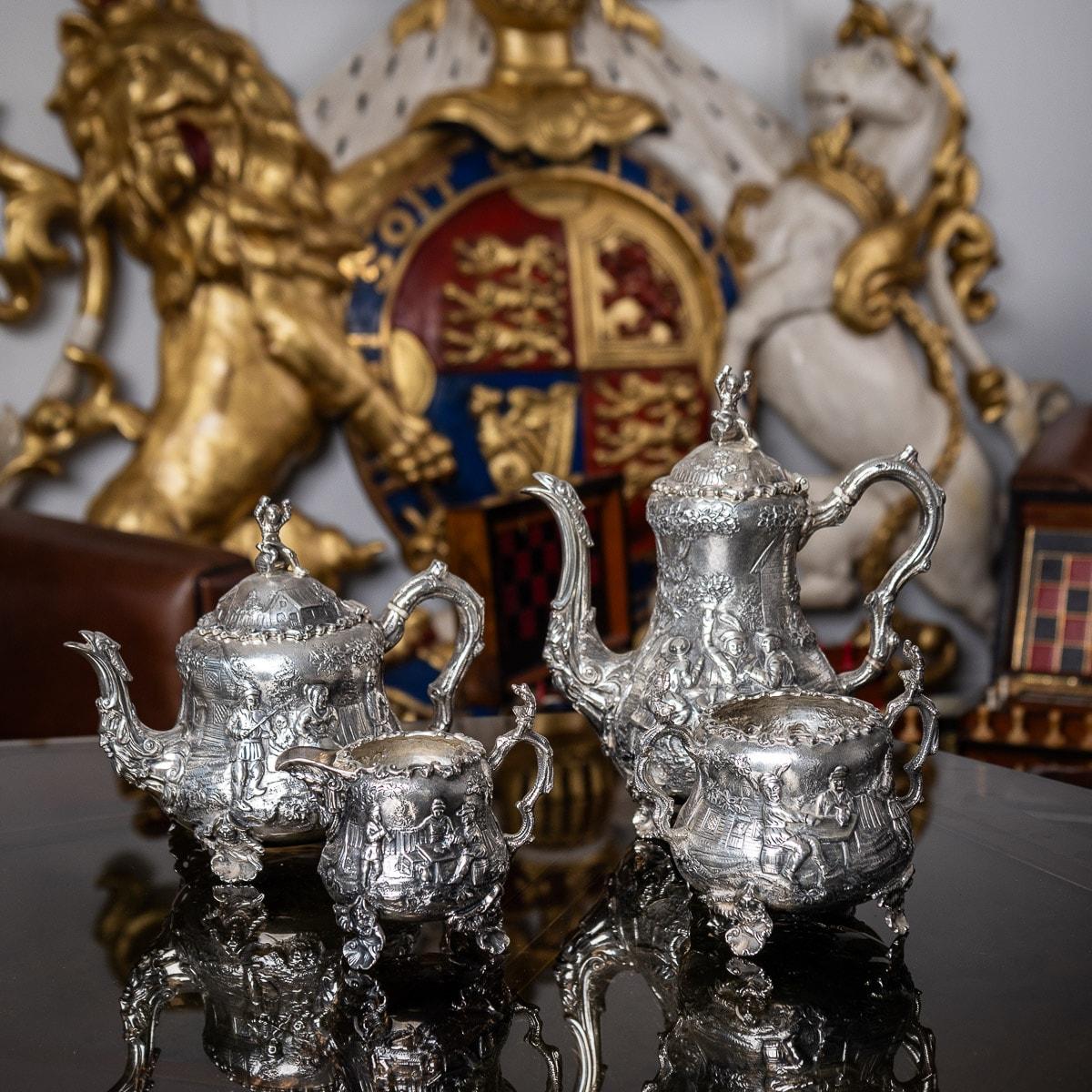 Antique 19th century Victorian unusual solid silver four-piece tea and coffee set, comprising of coffee pot, teapot, sugar bowl and milk jug, each pear-form body is chased and applied with rustic scenes of peasants merry-making, in the style of the